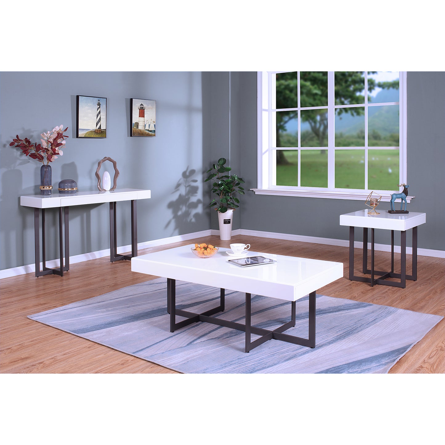 Left angled three-piece modern white high gloss and gunmetal storage coffee table set with hidden drawers in a living room with accessories