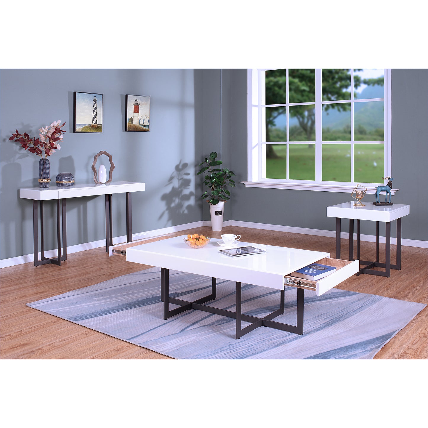 Left angled three-piece modern white high gloss and gunmetal storage coffee table set with hidden drawer open in a living room with accessories