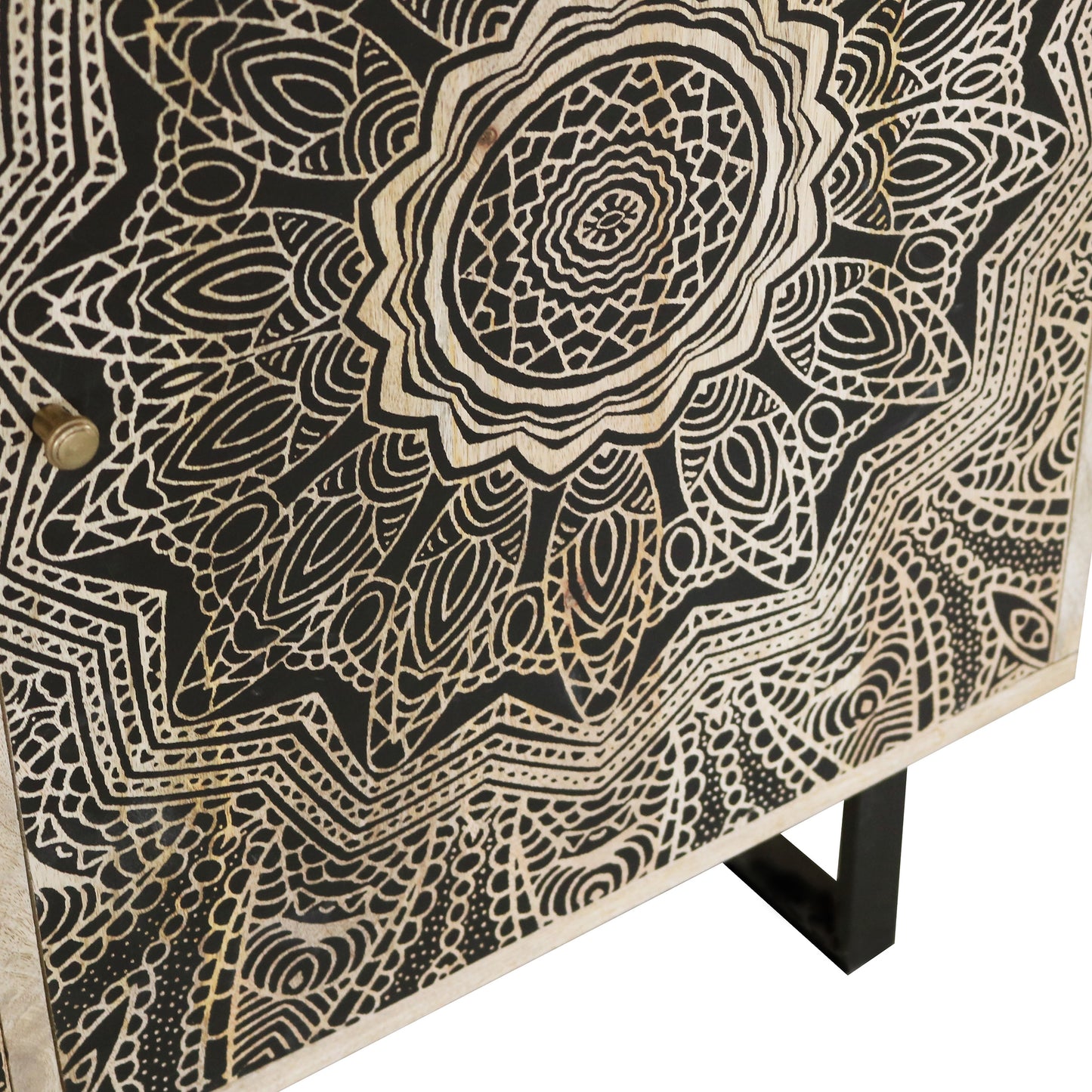 Right angled close-up door front detail view from a farmhouse natural and black three-door accent cabinet with medallion designs on a white background