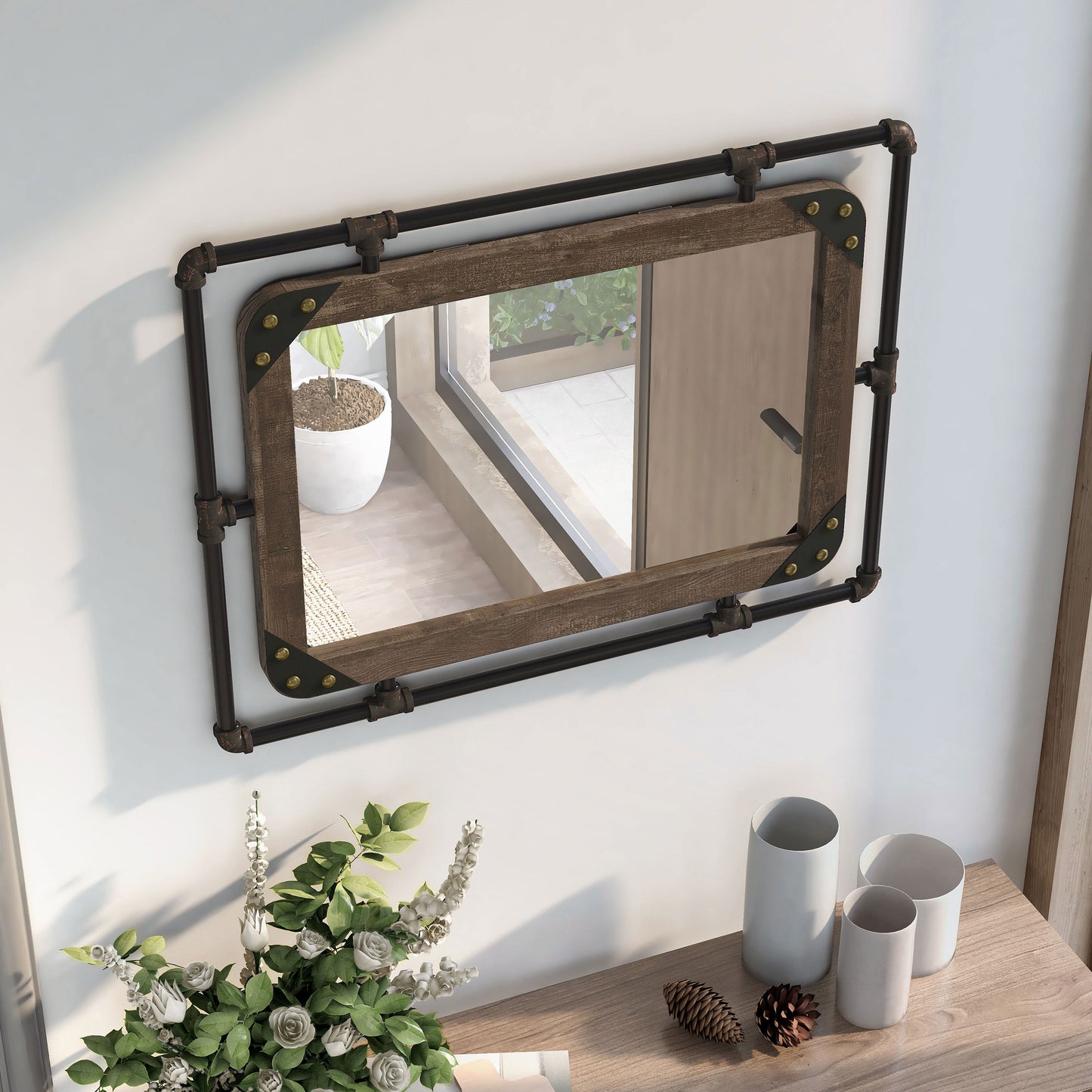 Right angled bird's eye view of an industrial reclaimed oak and water pipe wall mirror over a console with accessories