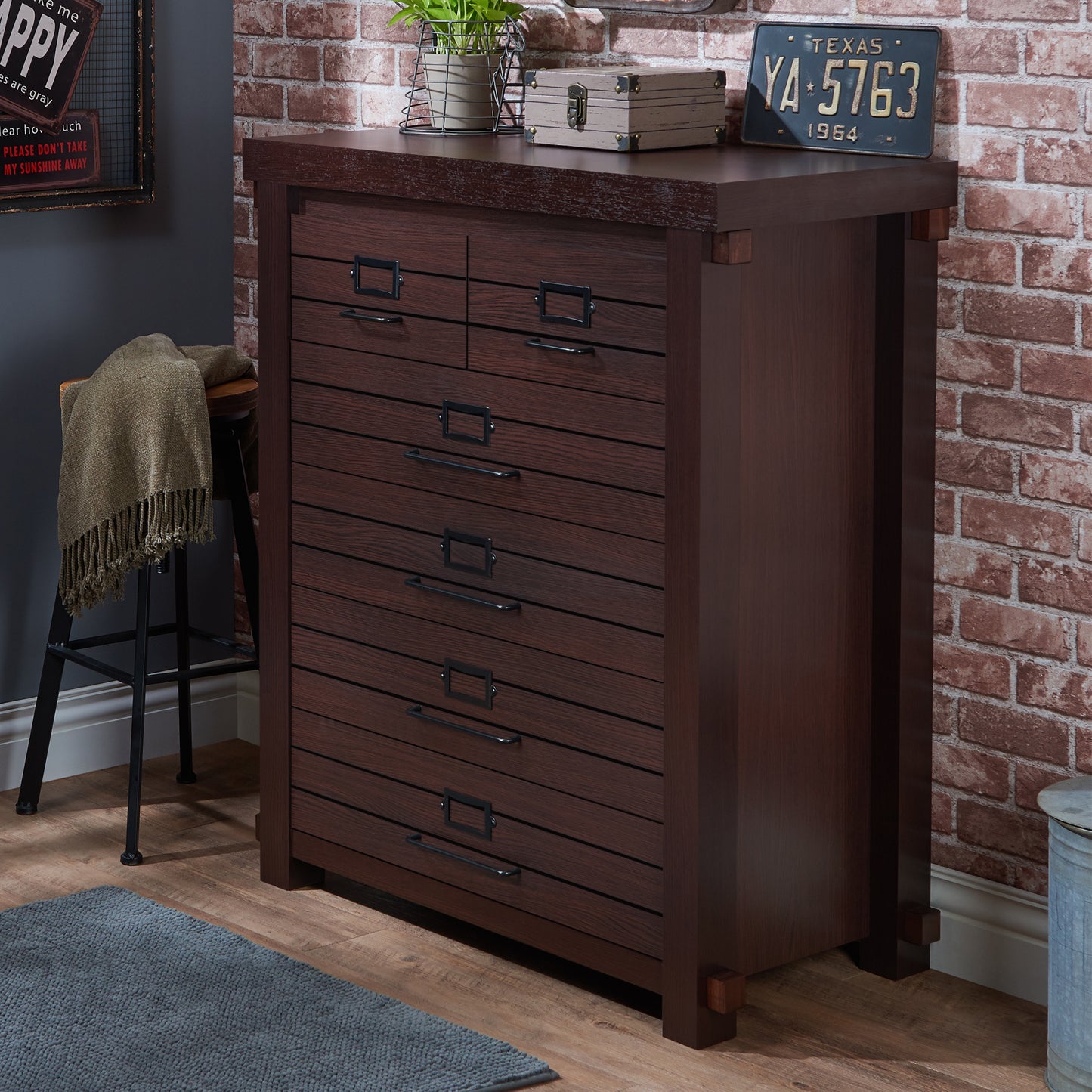 Left angled rustic espresso six-drawer plank chest dresser in a living space with accessories