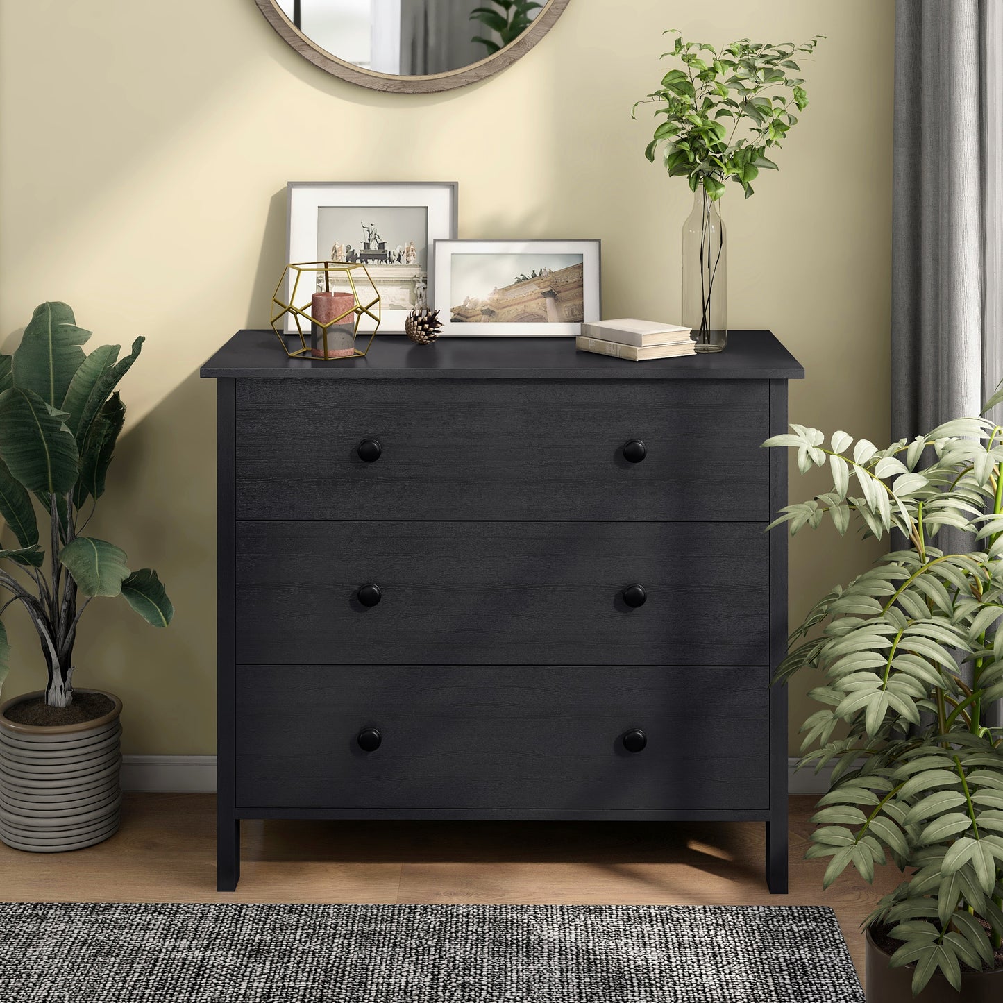 Front-facing transitional black three-drawer youth dresser in a bedroom with accessories