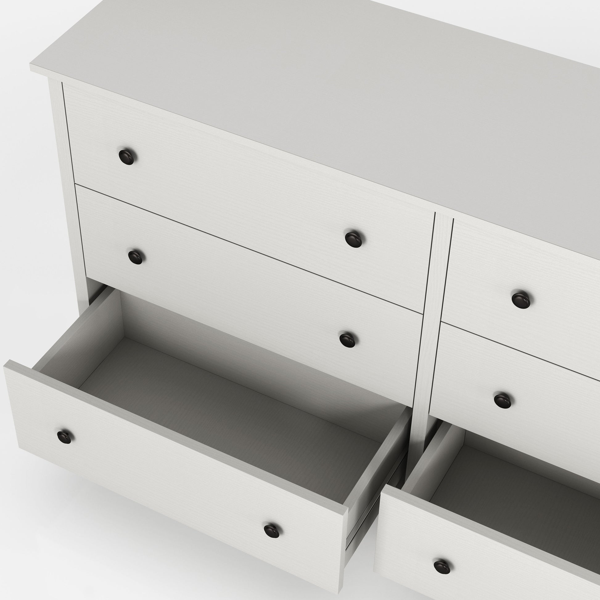 Left angled bird's eye close up view of a transitional white six-drawer youth dresser with two bottom drawers open on a white background
