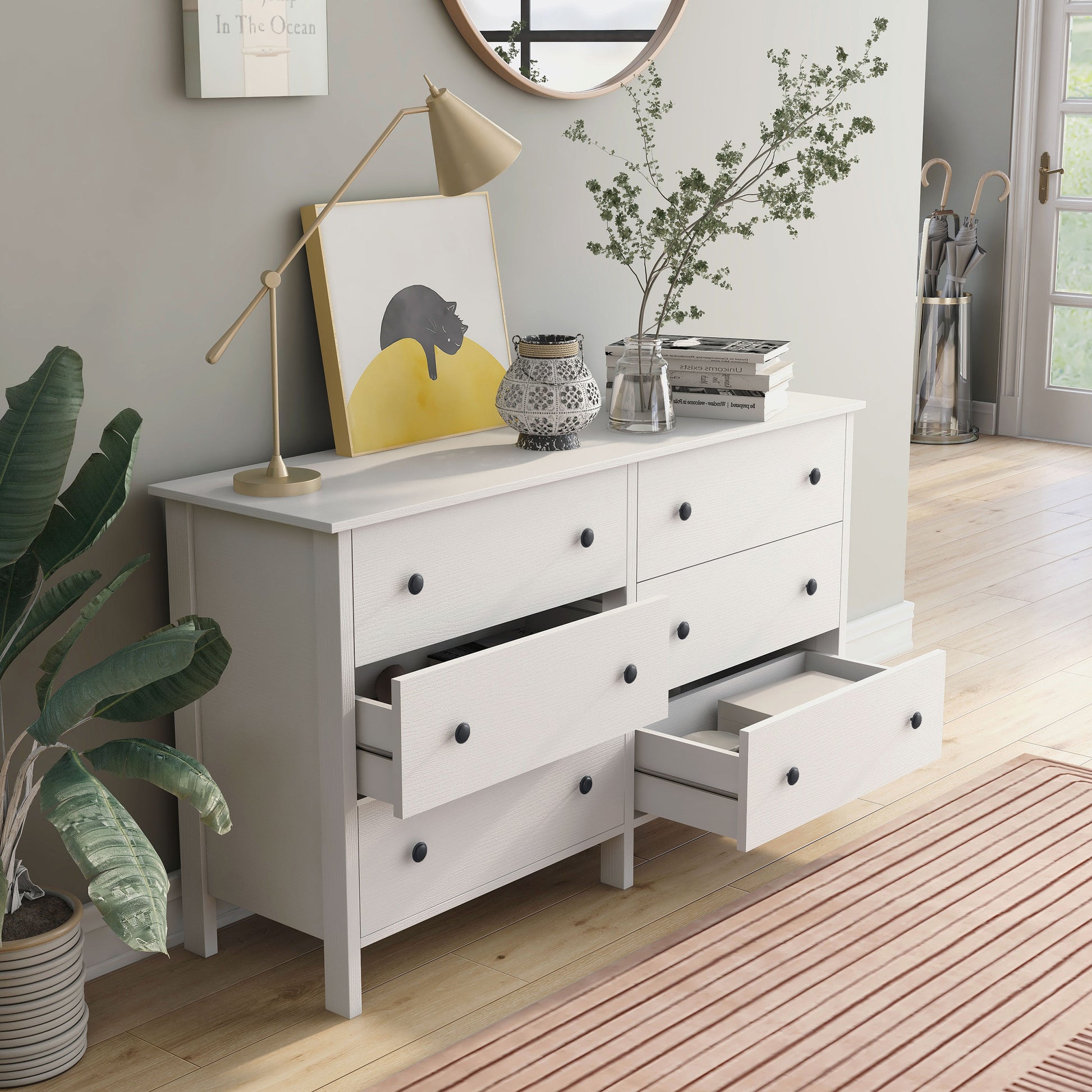 Right angled transitional white six-drawer youth dresser with two drawers open in a bedroom with accessories