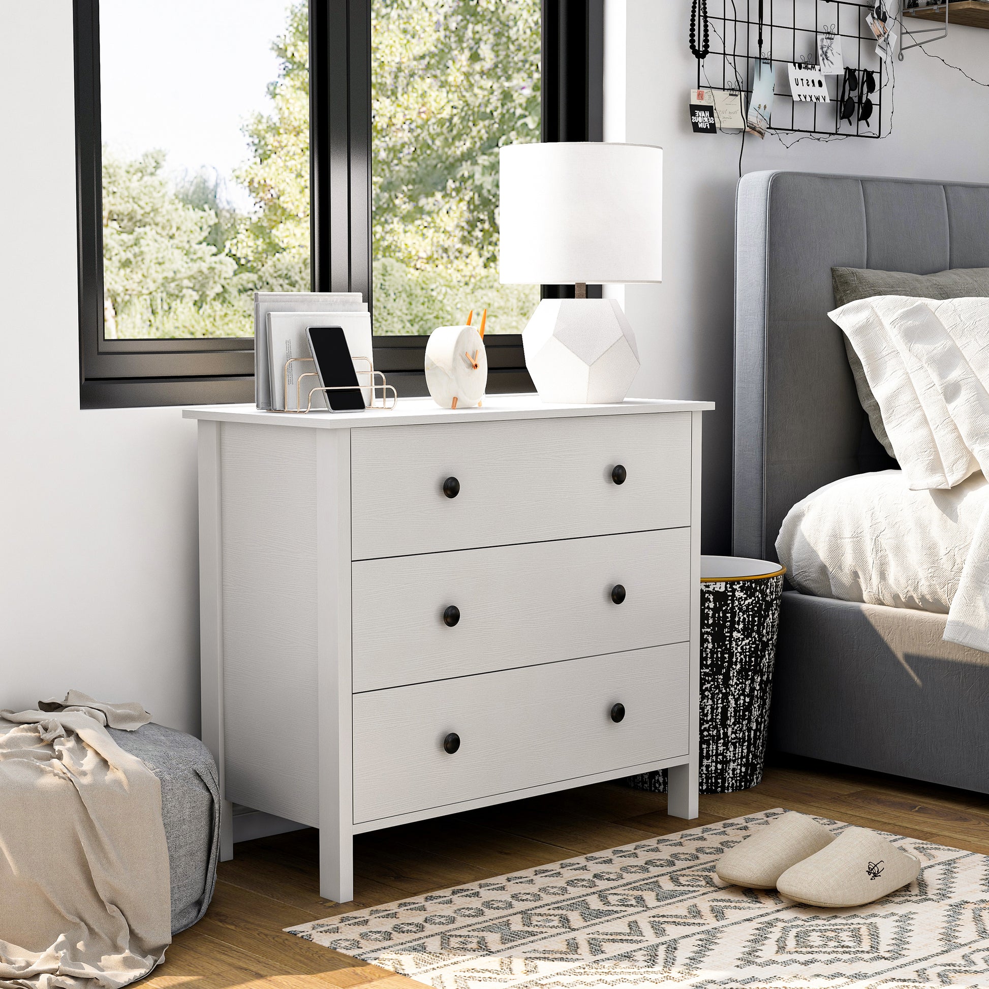 Right angled transitional white three-drawer youth dresser in a bedroom with accessories