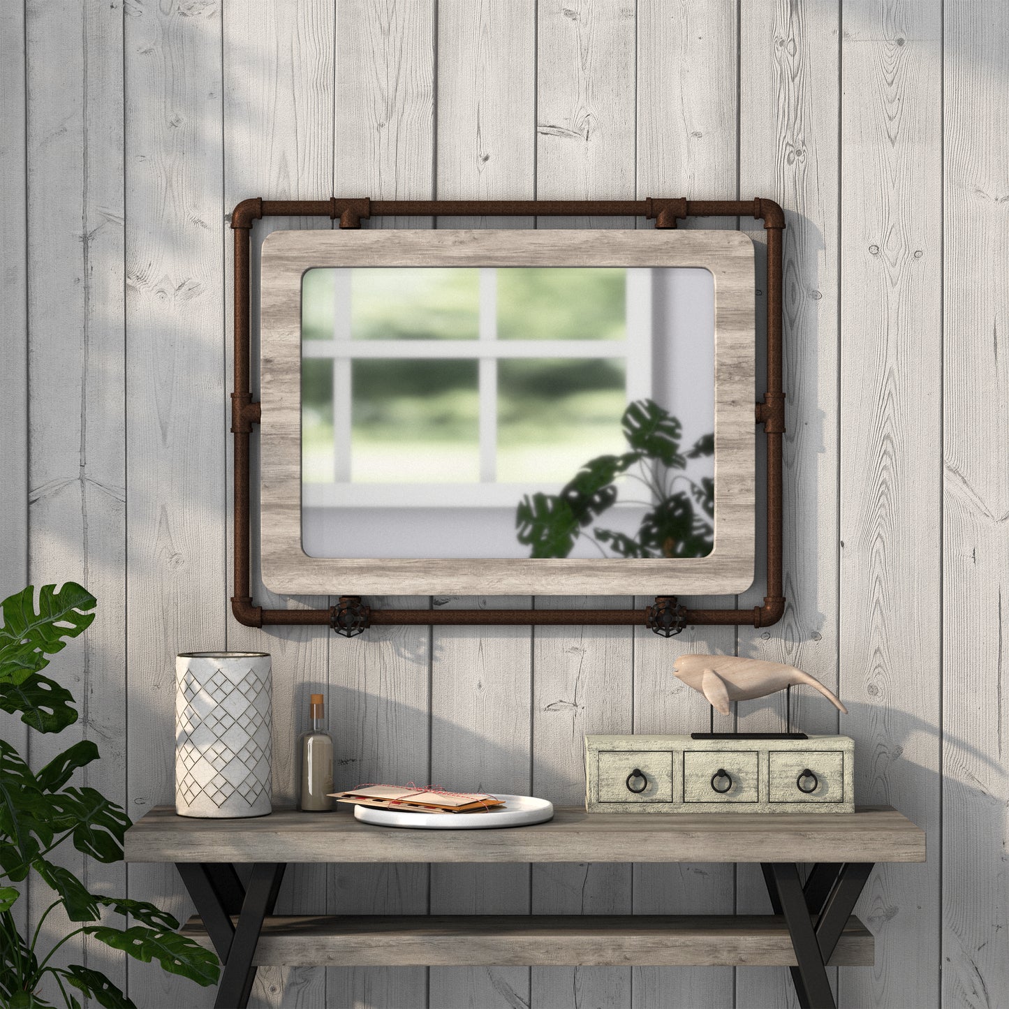 Front-facing industrial vintage gray oak and water pipe wall mirror over a table with accessories