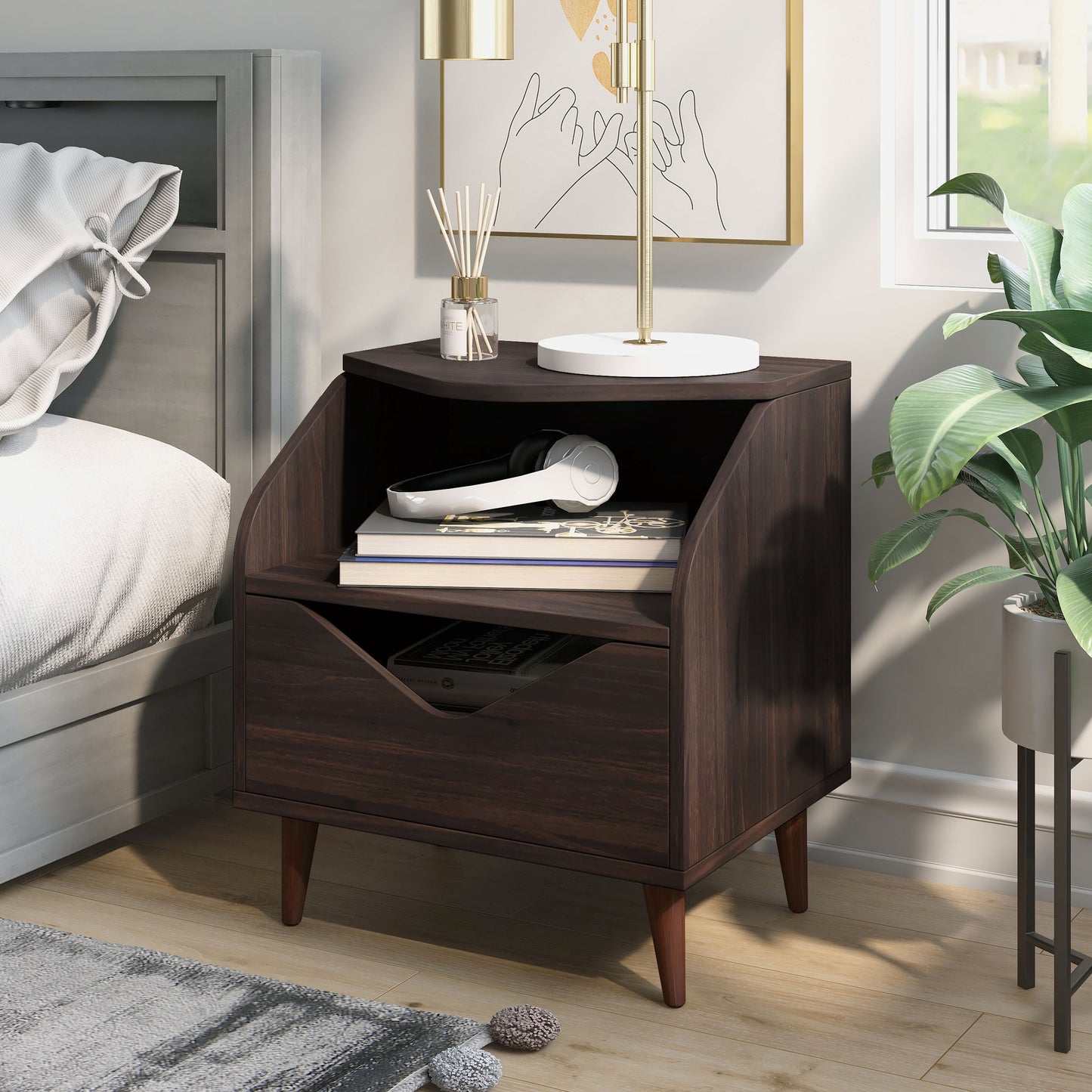 Left angled mid-century modern wenge one-drawer end table in a bedroom with accessories