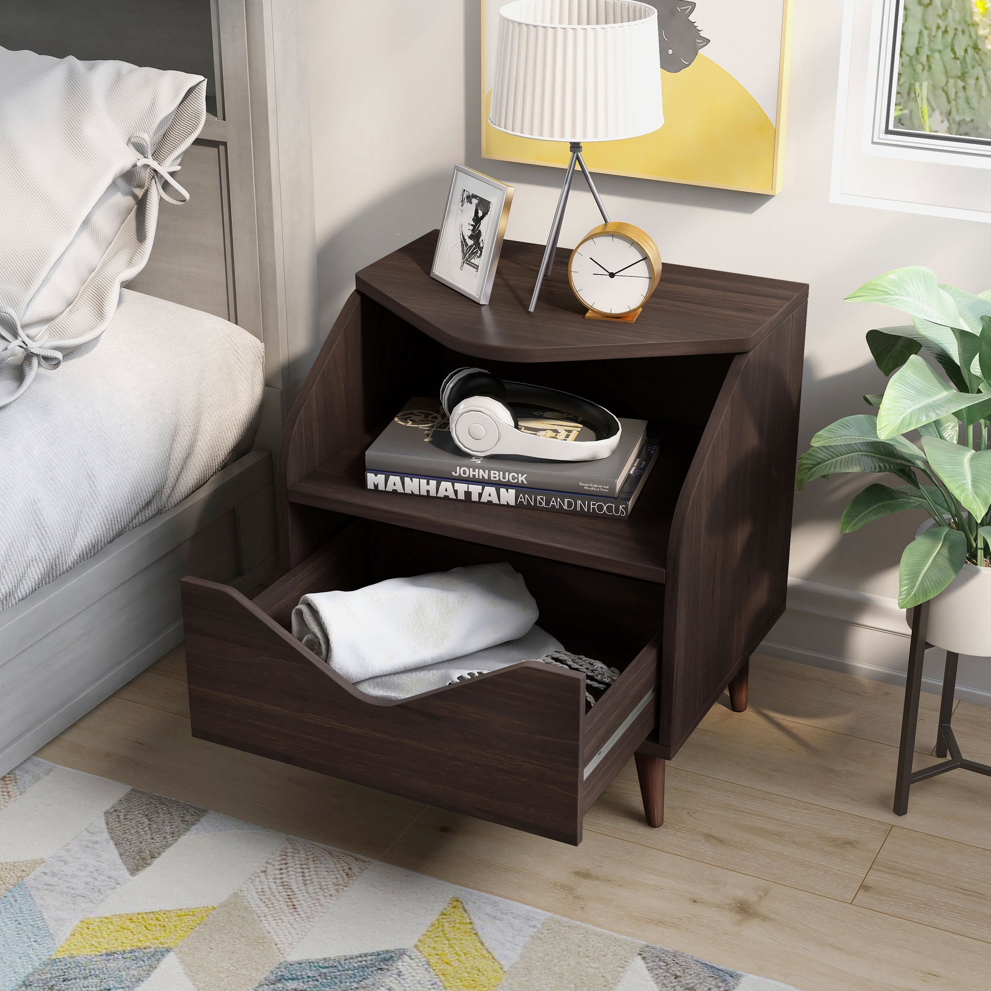 Left angled upper view of a mid-century modern wenge one-drawer end table with drawer open in a bedroom with accessories