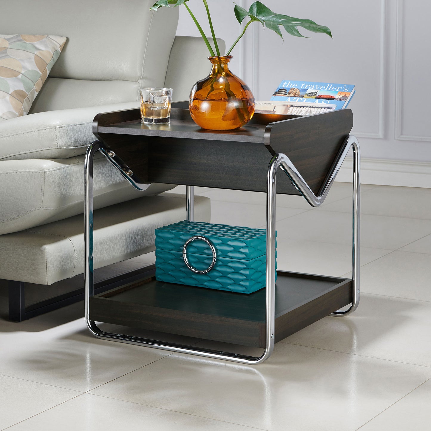Left angled contemporary wenge and chrome three-shelf end table in a living room with accessories