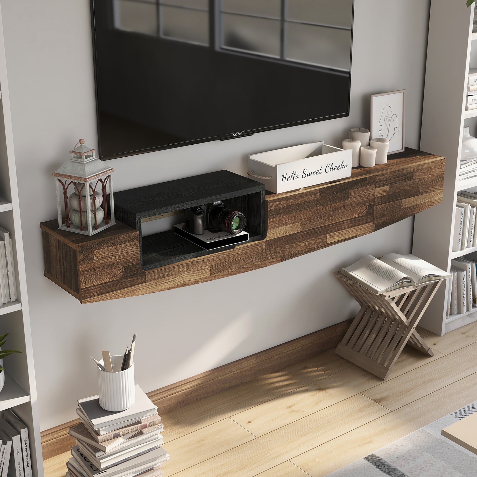 Right angled bird's eye view of a farmhouse light hickory and black one-drawer lift-top floating TV console in a living room with accessories