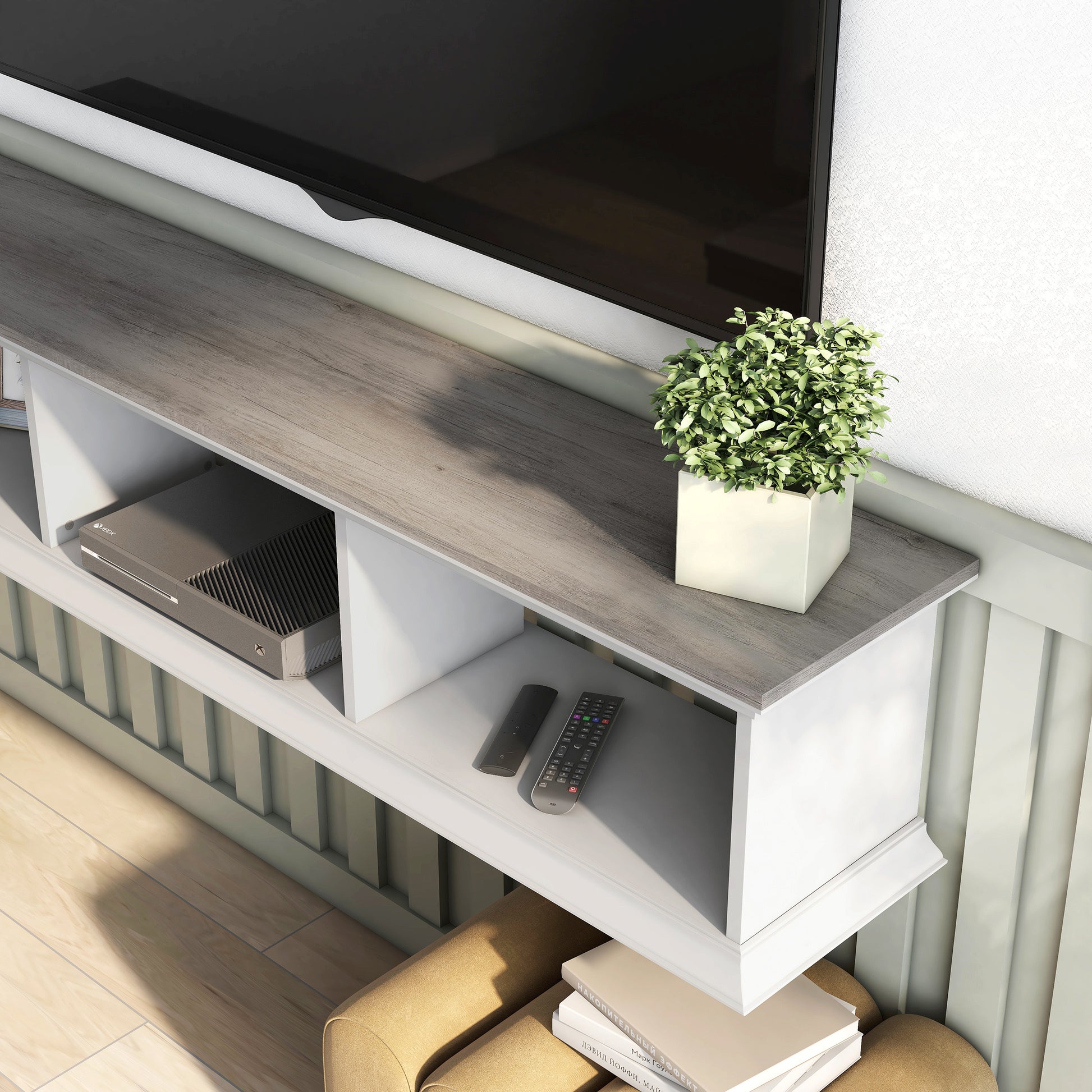 Left angled upper view tabletop close up of a transitional vintage gray oak and white floating TV stand with three shelves in a living room with accessories