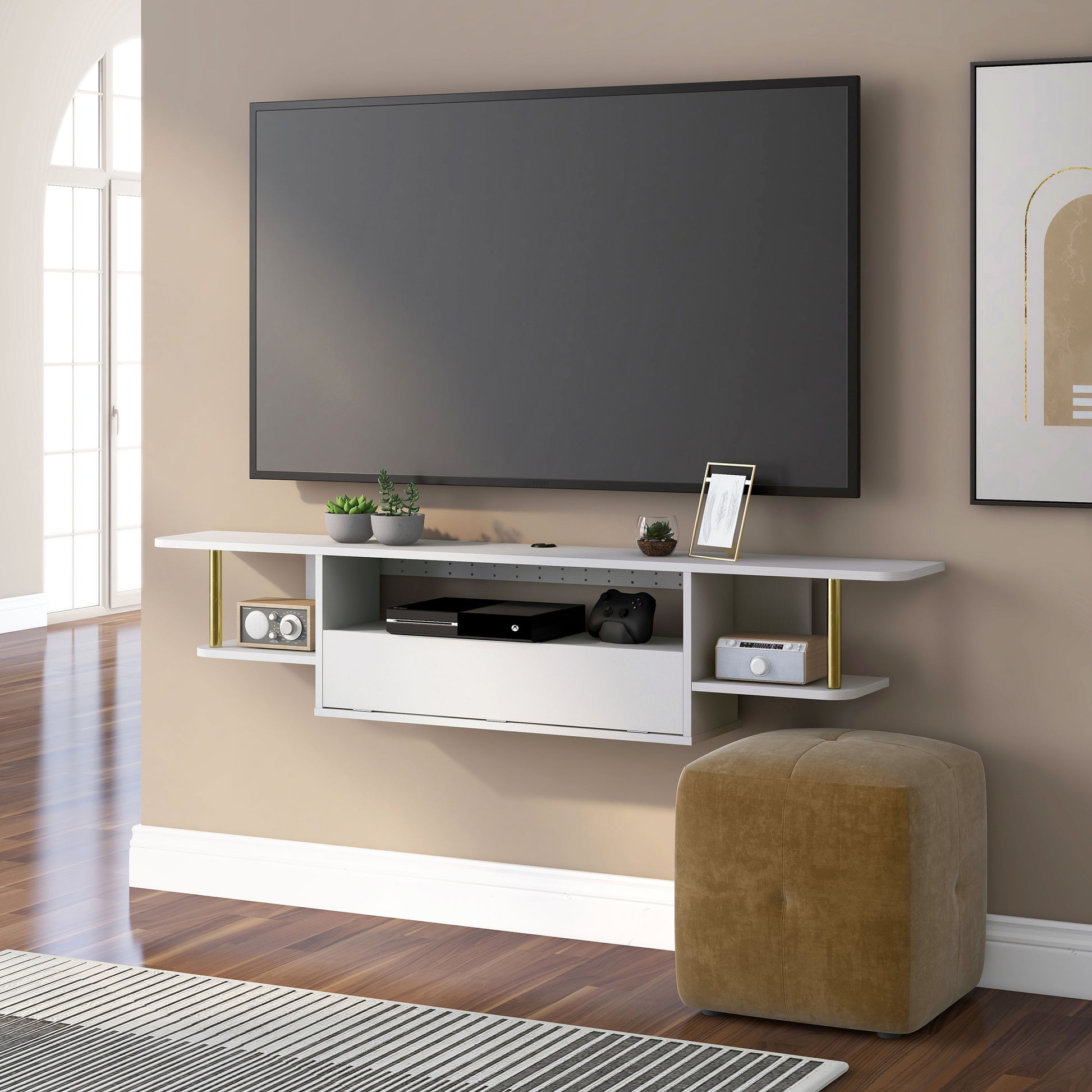 Left angled modern white and gold three-shelf floating TV stand in a living room with accessories