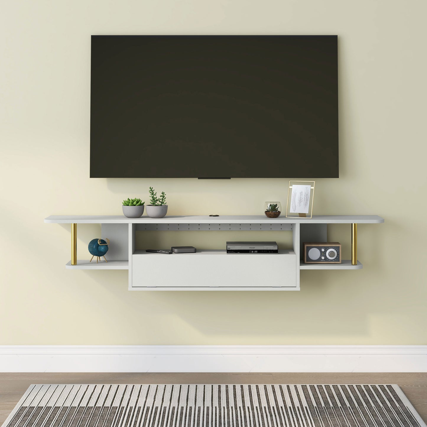 Front-facing modern white and gold three-shelf floating TV stand in a living room with accessories