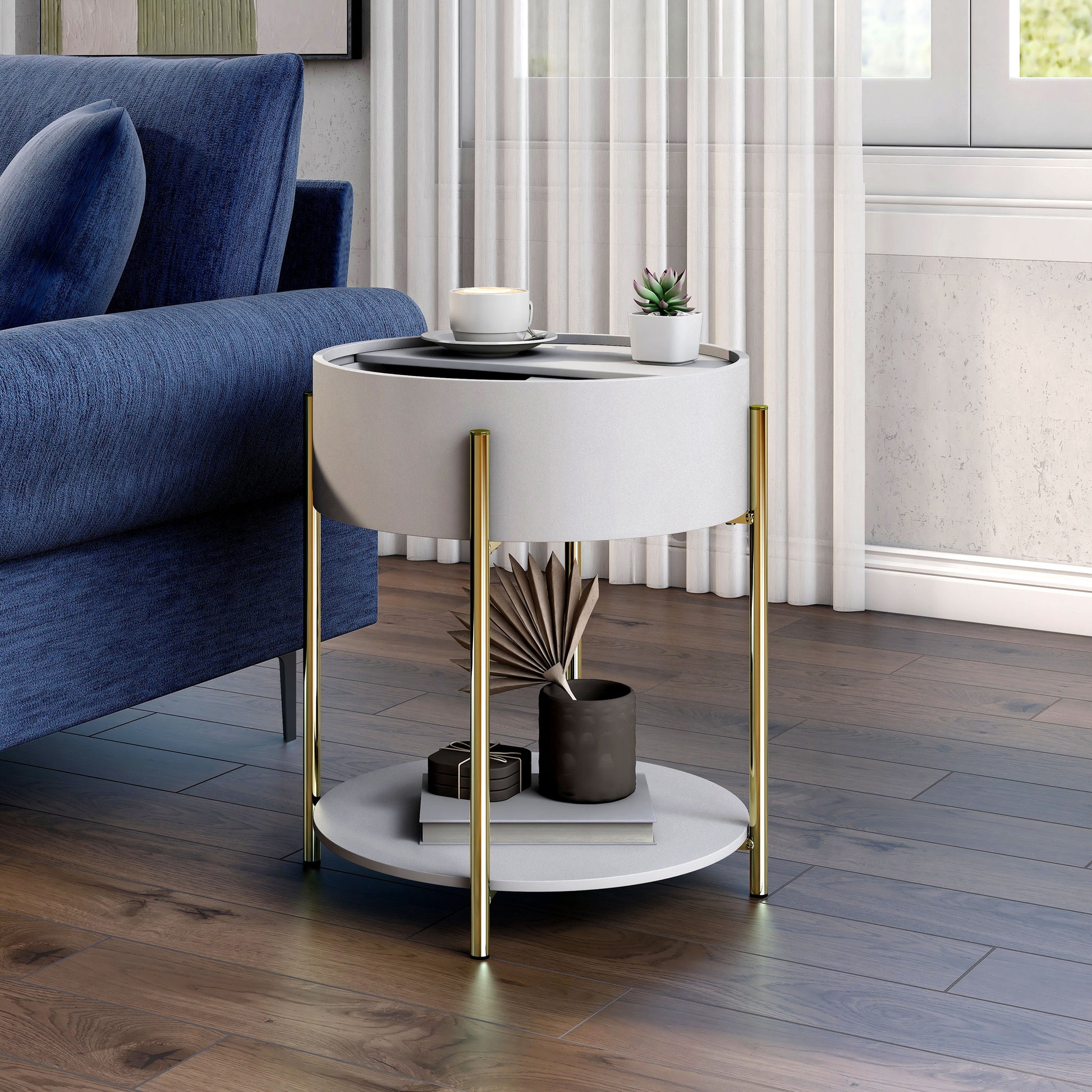 Left angled modern white and gold round storage end table with top partially open in a living room with accessories