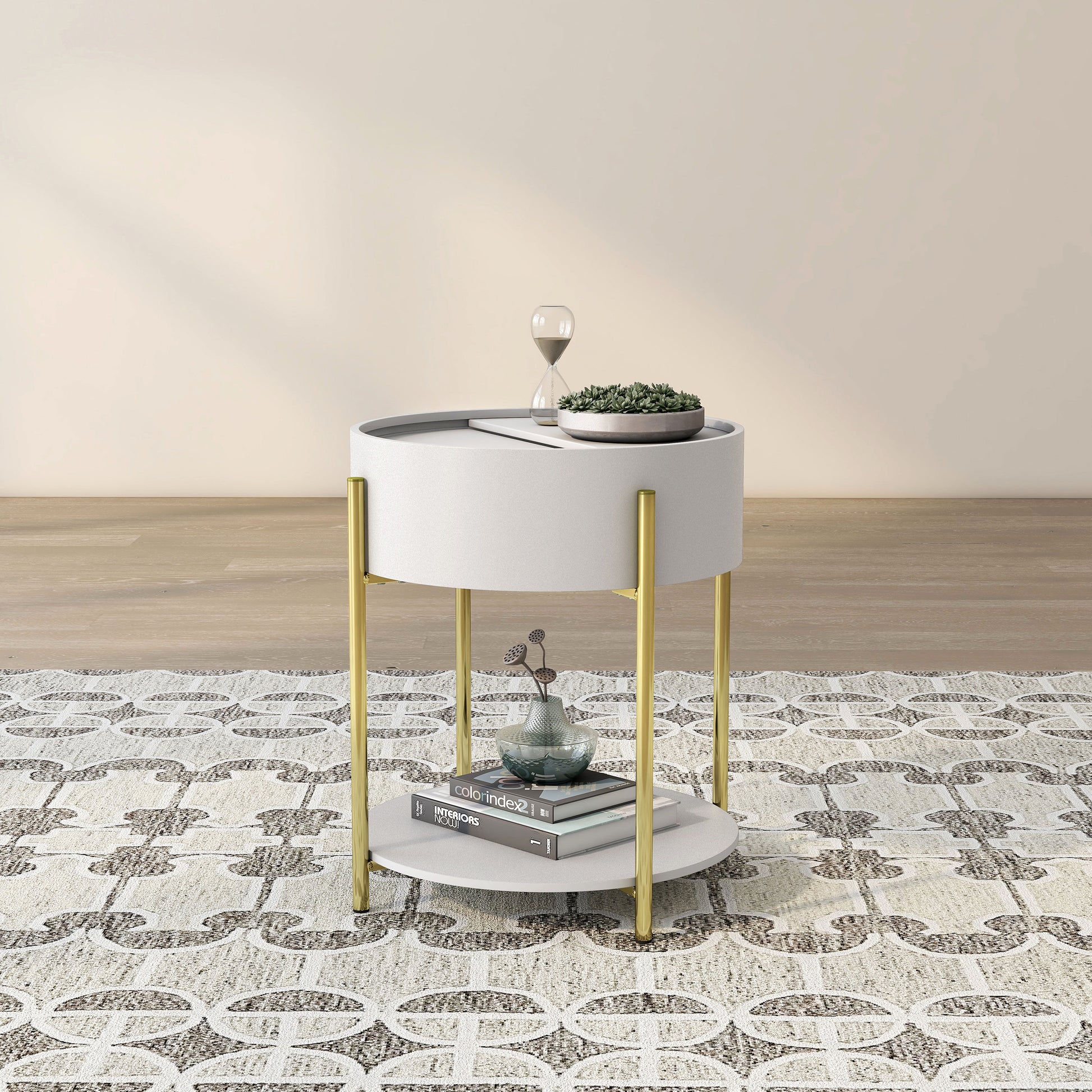 Angled modern white and gold round storage end table on a rug with accessories