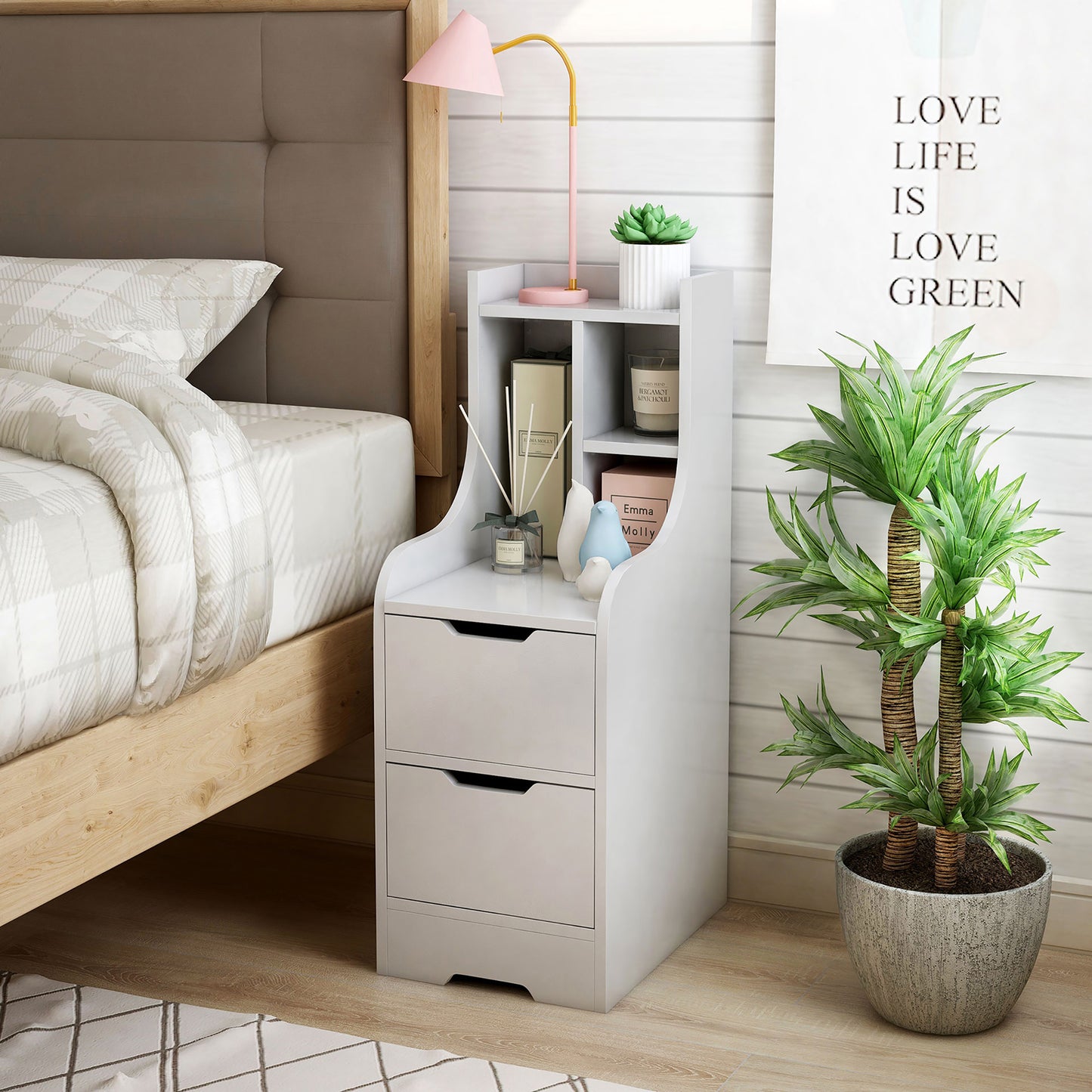 Left angled modern white two-drawer nightstand with shelves in a bedroom with accessories