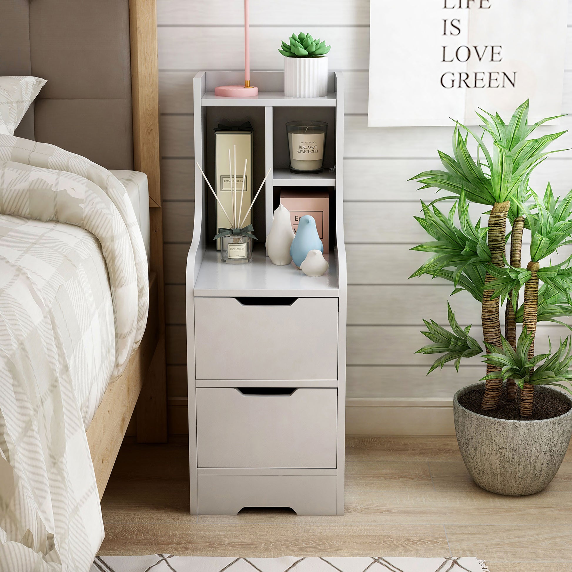 Front-facing modern white two-drawer nightstand with shelves in a bedroom with accessories