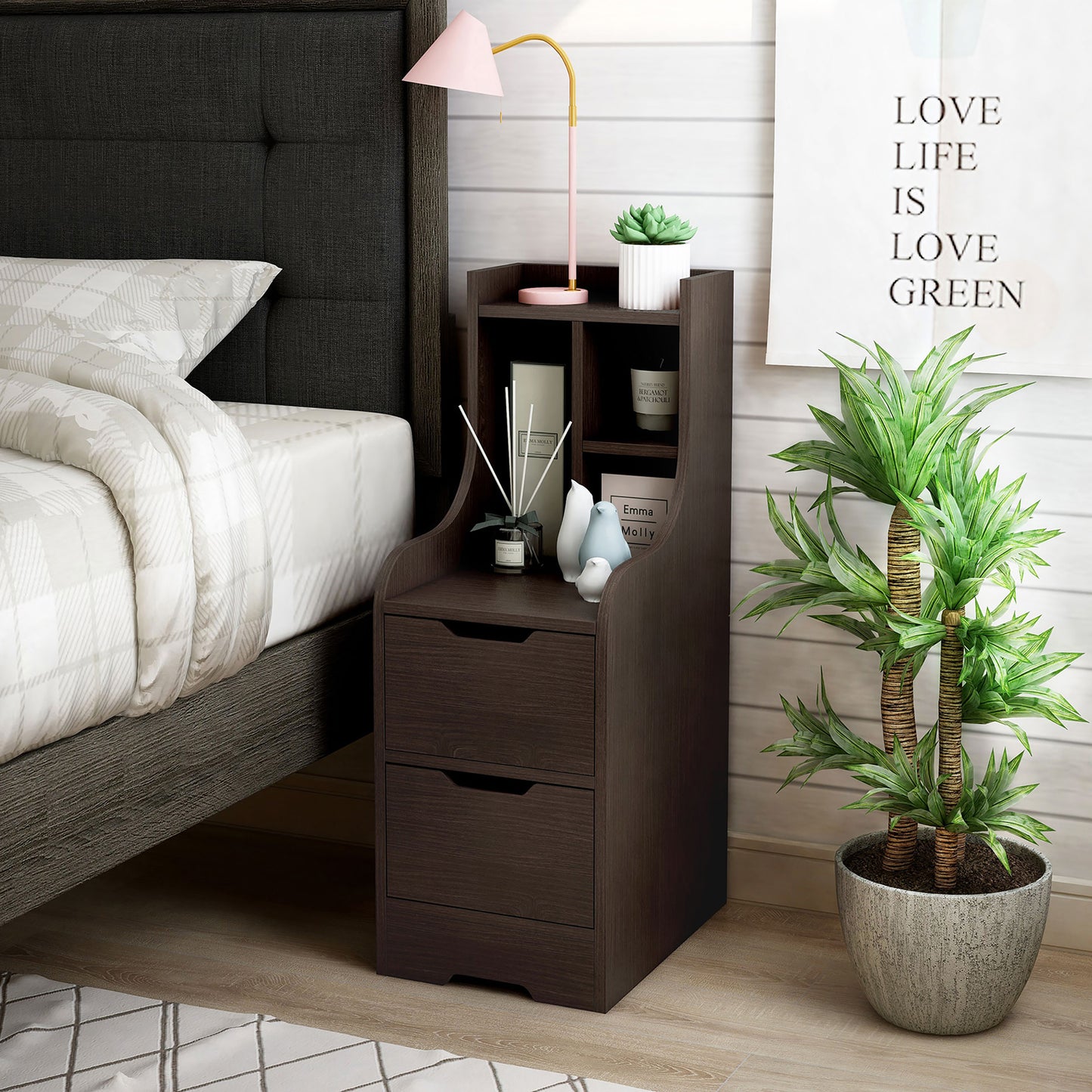 Left angled modern walnut two-drawer nightstand with shelves in a bedroom with accessories