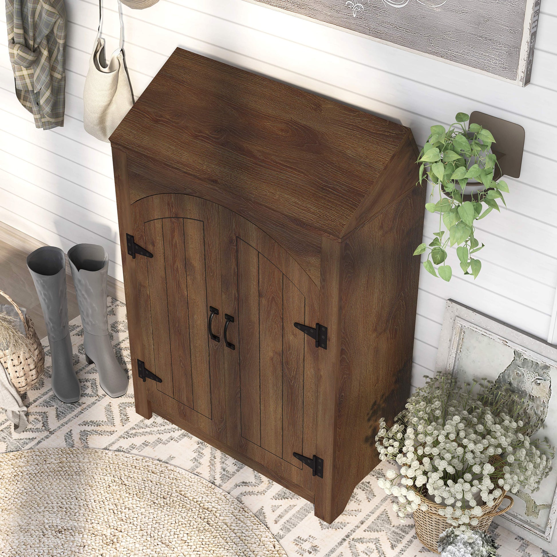 Left angled bird's eye view of a farmhouse distressed walnut four-shelf shoe cabinet with a lift-top in an entryway with accessories