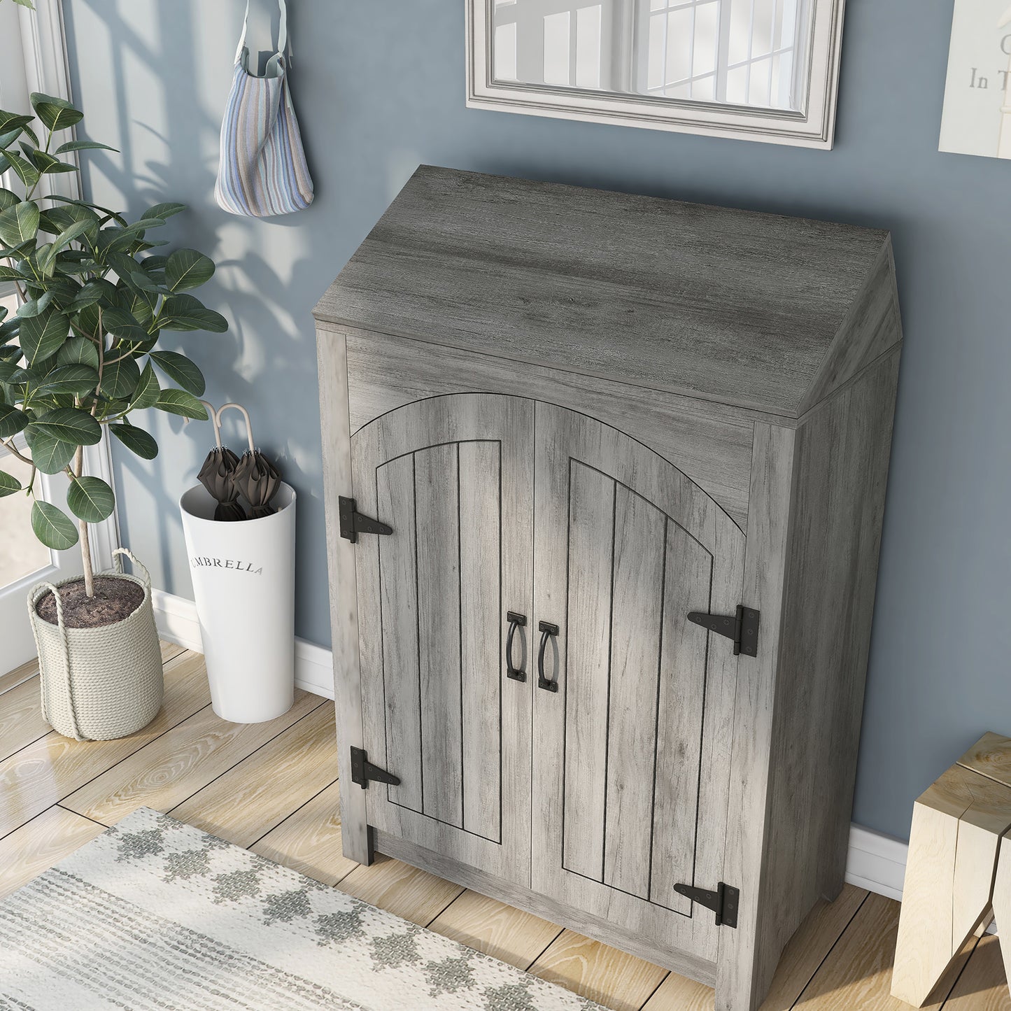 Left angled bird's eye view of a farmhouse vintage gray oak four-shelf shoe cabinet with a lift-top in an entryway with accessories