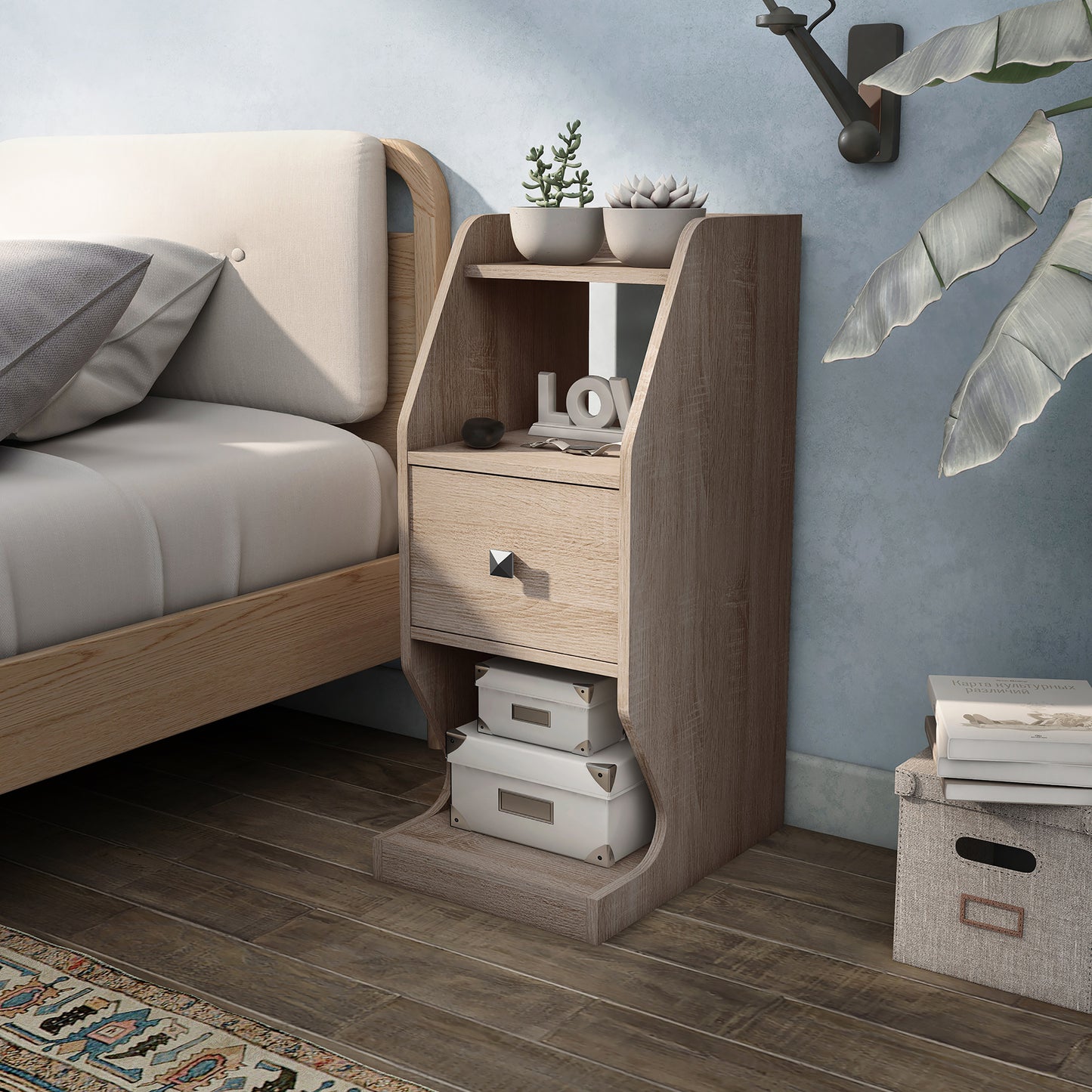 Left angled transitional natural oak tiered one-drawer nightstand in a bedroom with accessories