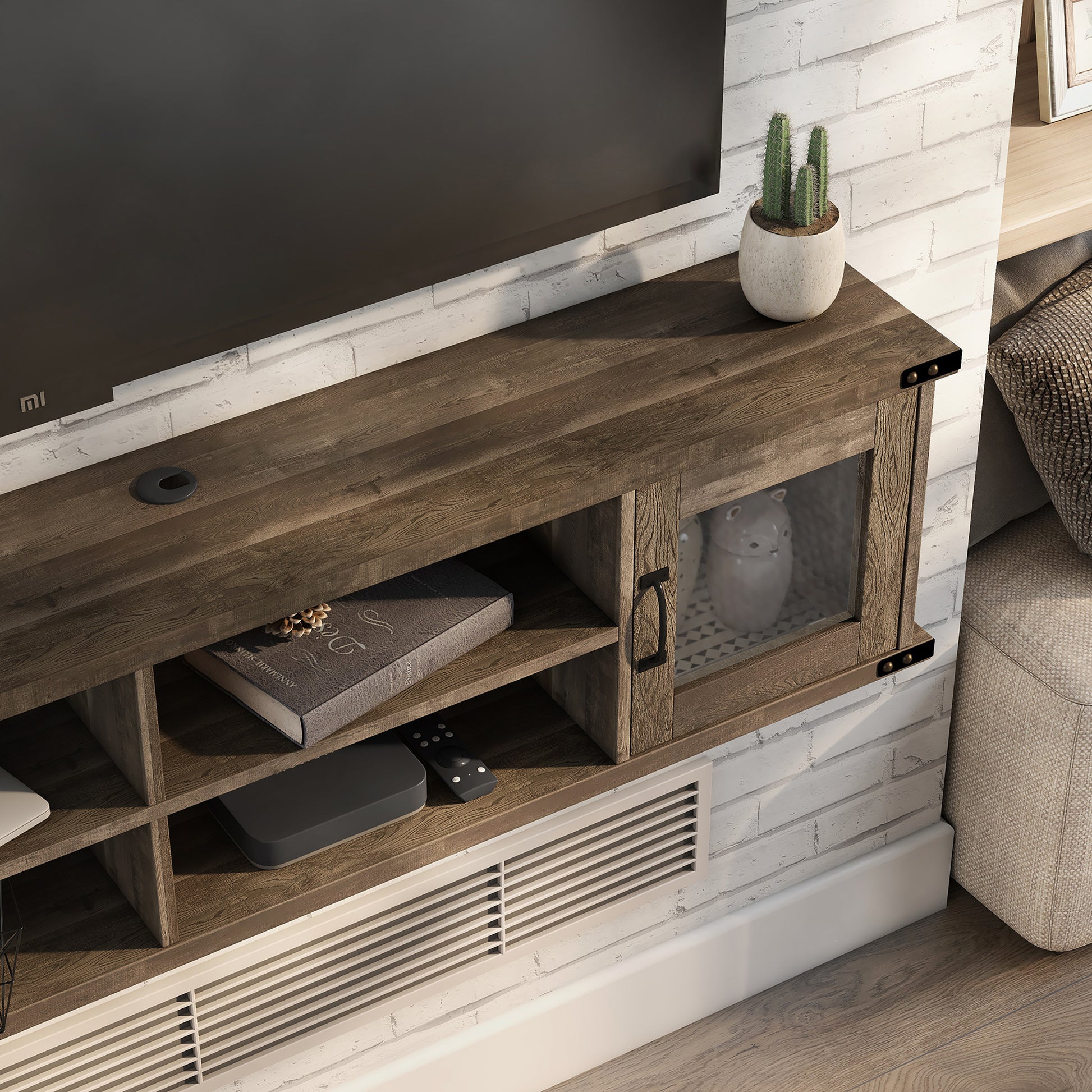 Right angled close-up view of a modern reclaimed oak four-shelf wall mountable TV stand with glass doors in a living room with accessories