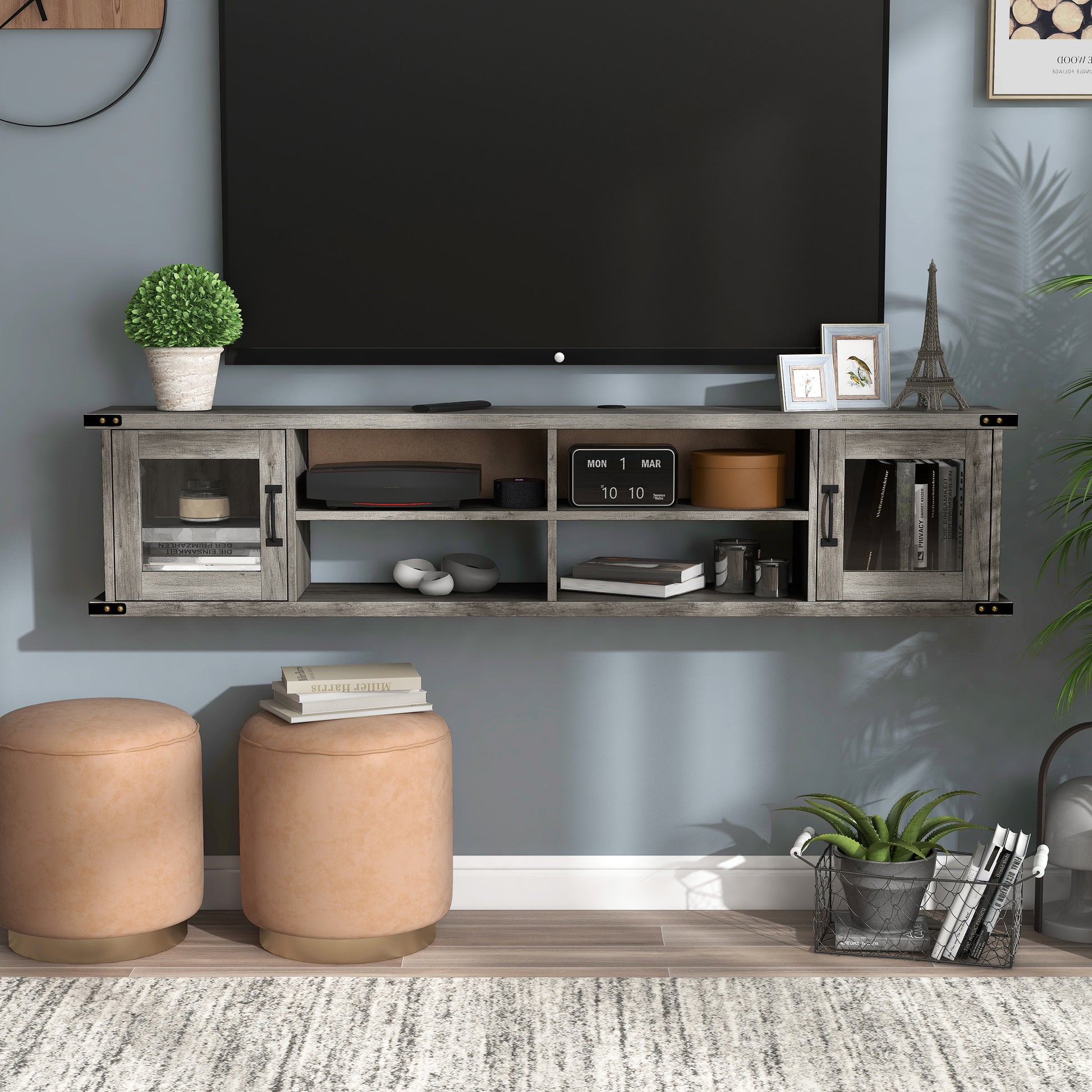Front-facing modern vintage gray oak four-shelf wall mountable TV stand with glass doors in a living room with accessories