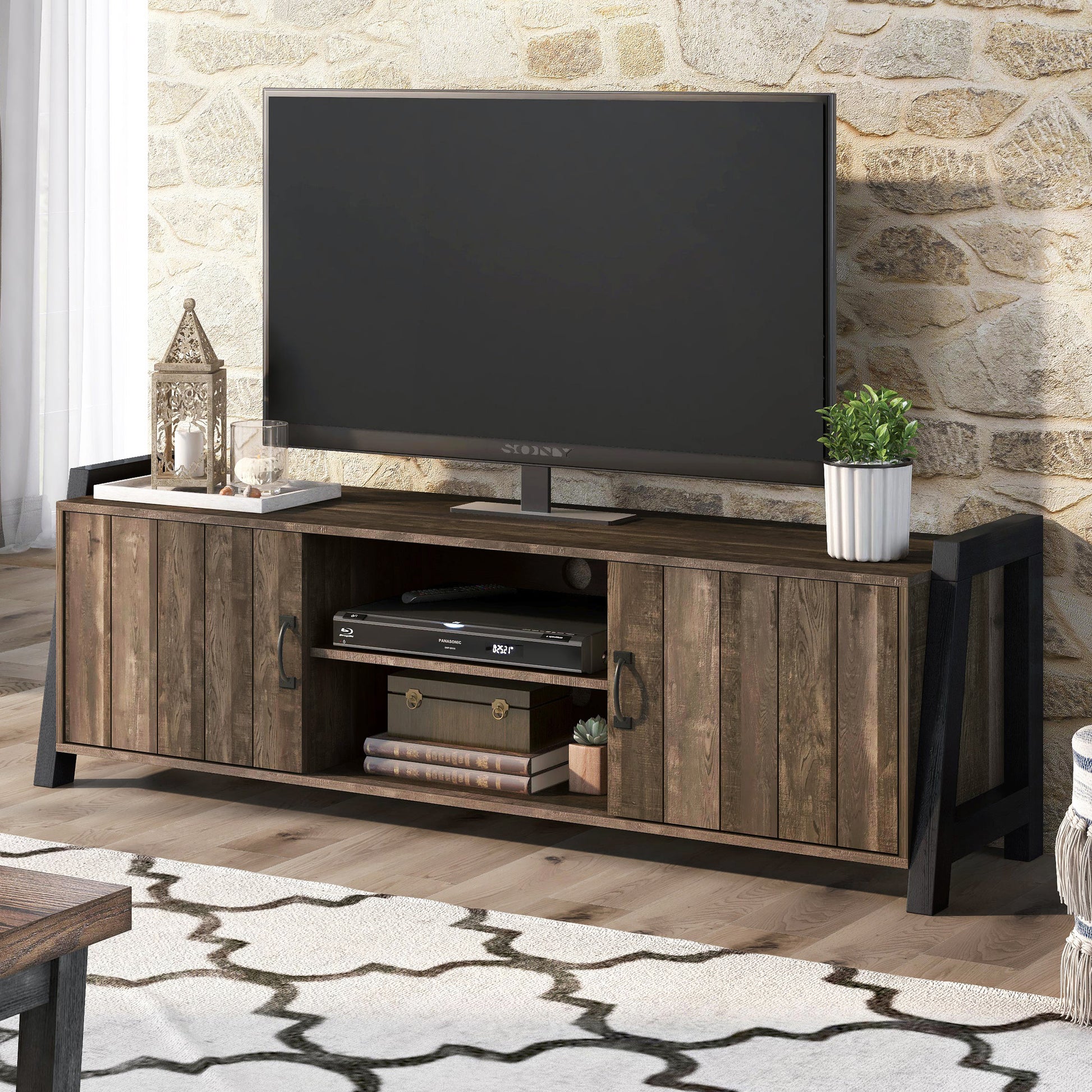 Left angled farmhouse reclaimed oak and black six-shelf TV stand in a living room with accessories