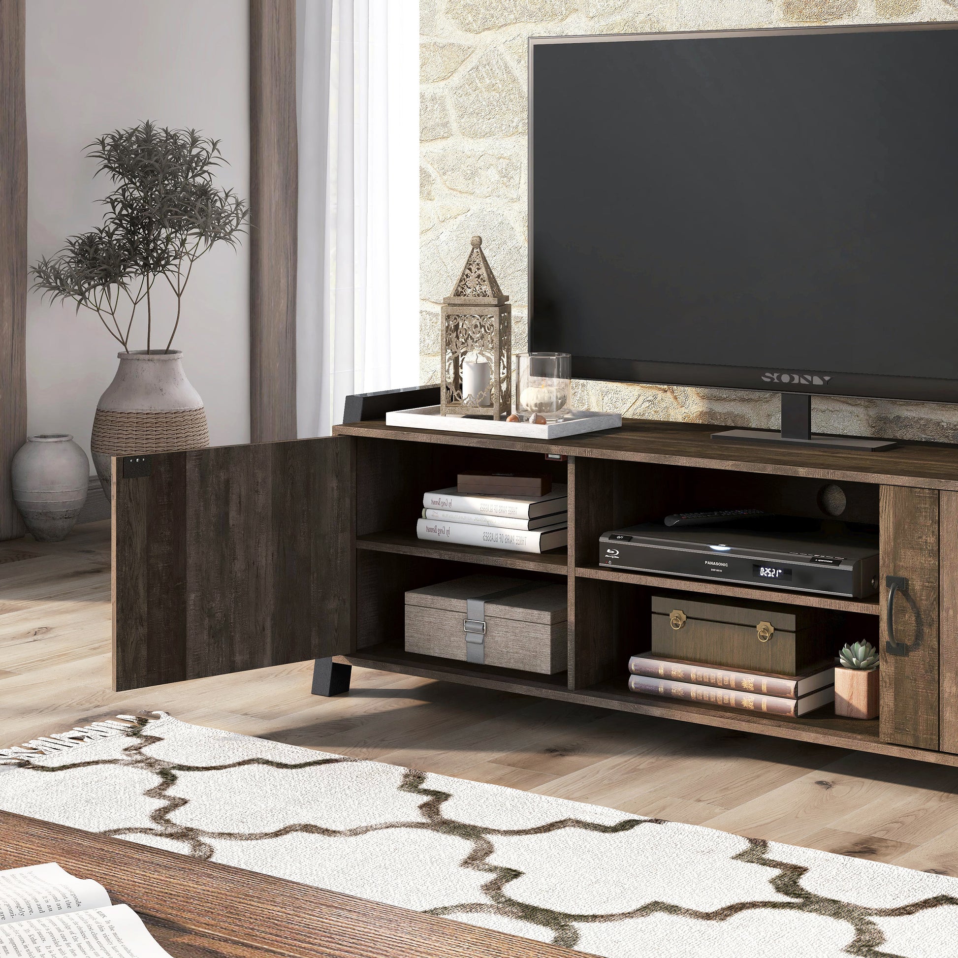 Left angled close-up view of a farmhouse reclaimed oak and black six-shelf TV stand with one door open in a living room with accessories