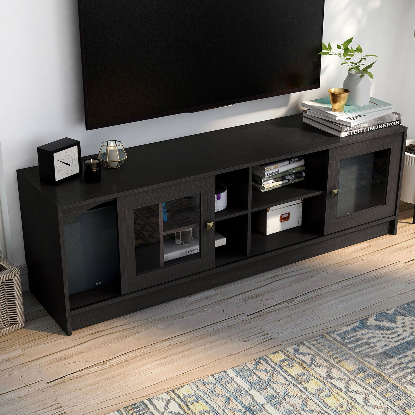 Right angled upper view of a transitional espresso two-sliding door TV stand in a living room with accessories
