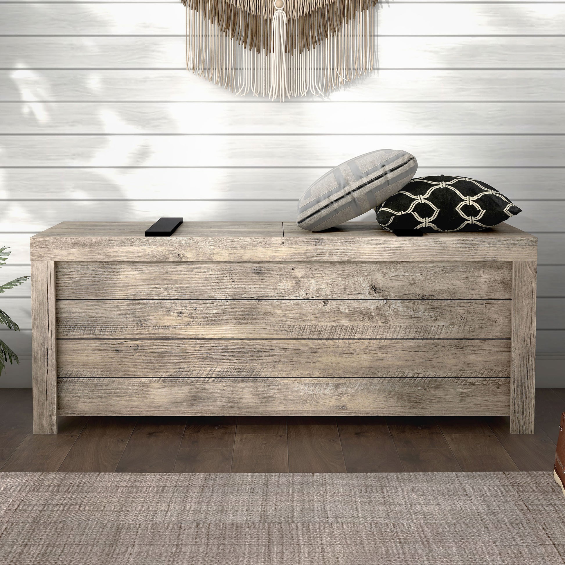 Front-facing farmhouse weathered oak sliding top storage bench in an entryway with accessories