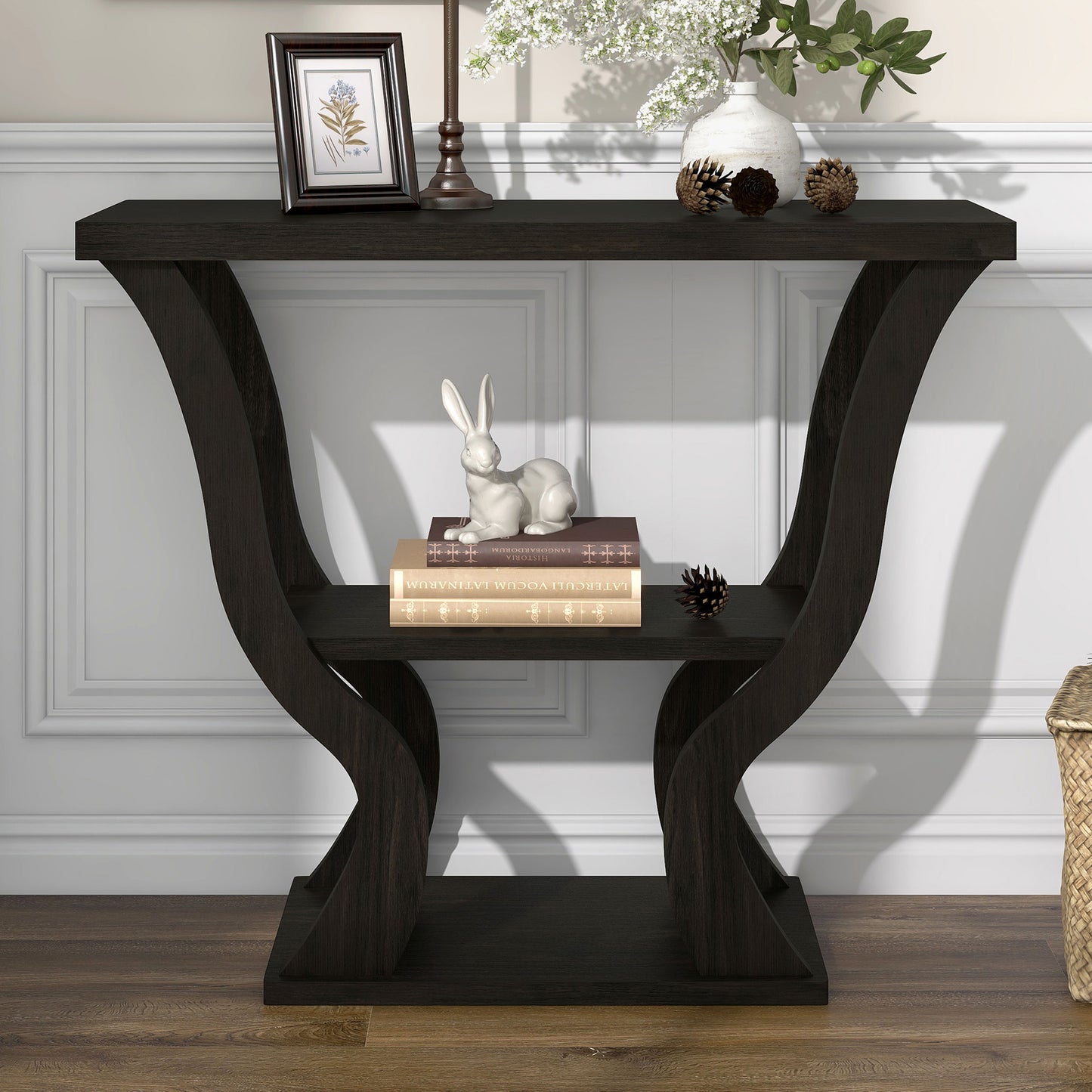 Front-facing transitional espresso curvy console table in a living area with accessories