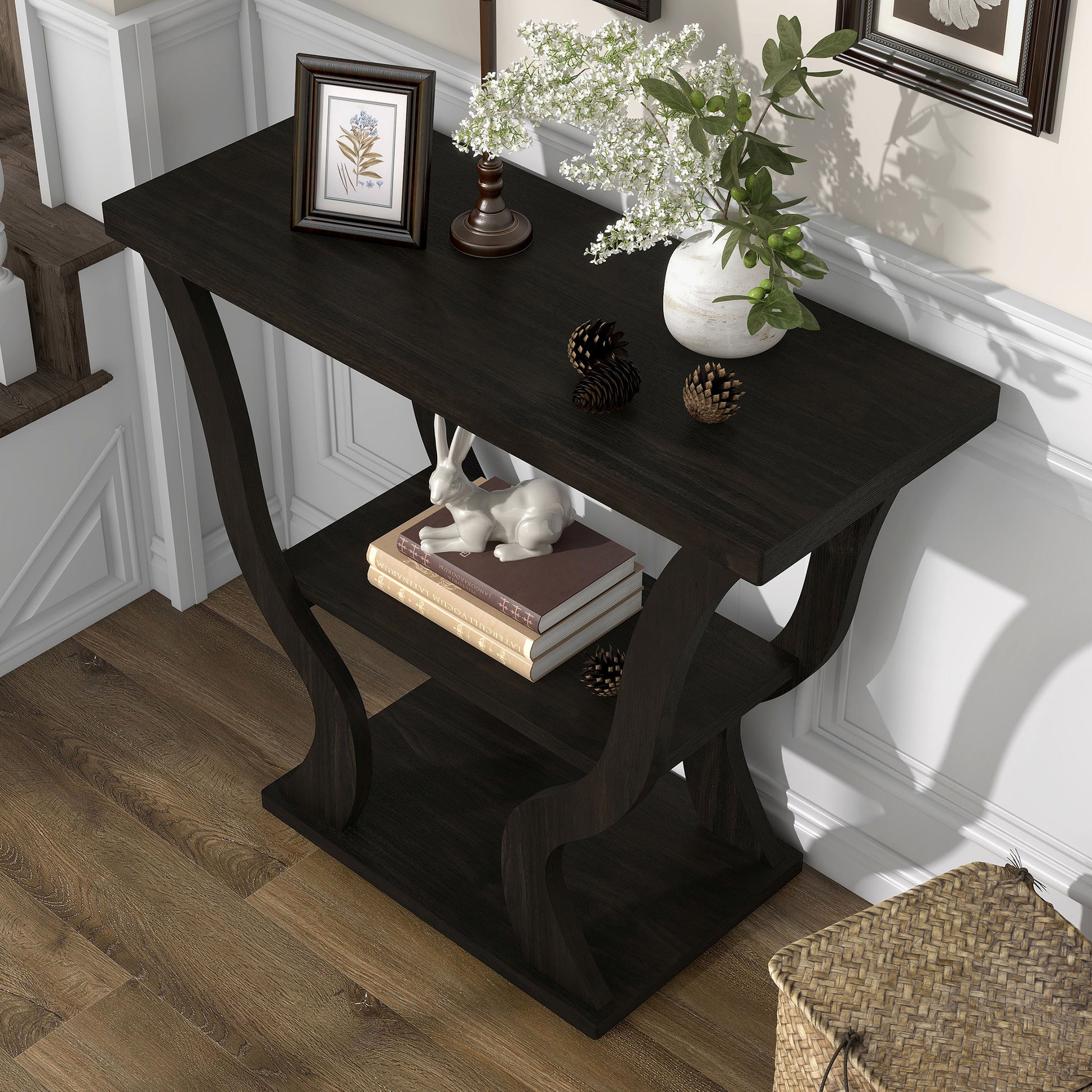Left angled bird's eye view of a transitional espresso curvy console table in a living area with accessories