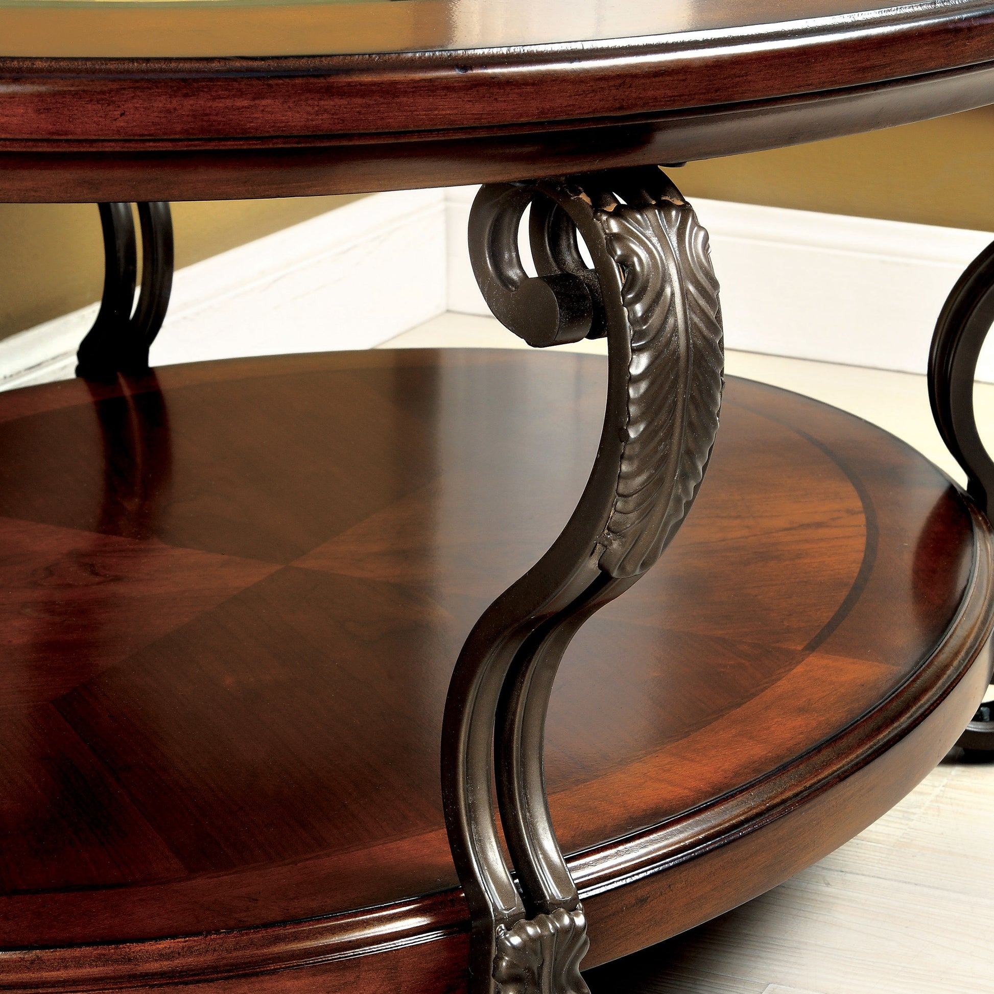Angled close-up decorative scroll leg view of a traditional brown cherry and glass oval coffee table in a living area