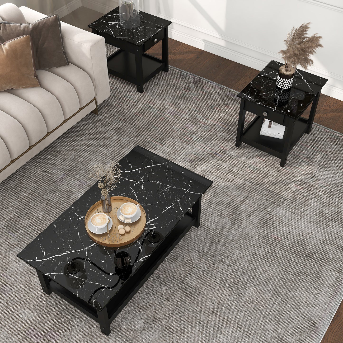 Right angled bird's eye view of a three-piece modern black and faux marble coffee table set with lower shelves in a living area with accessories