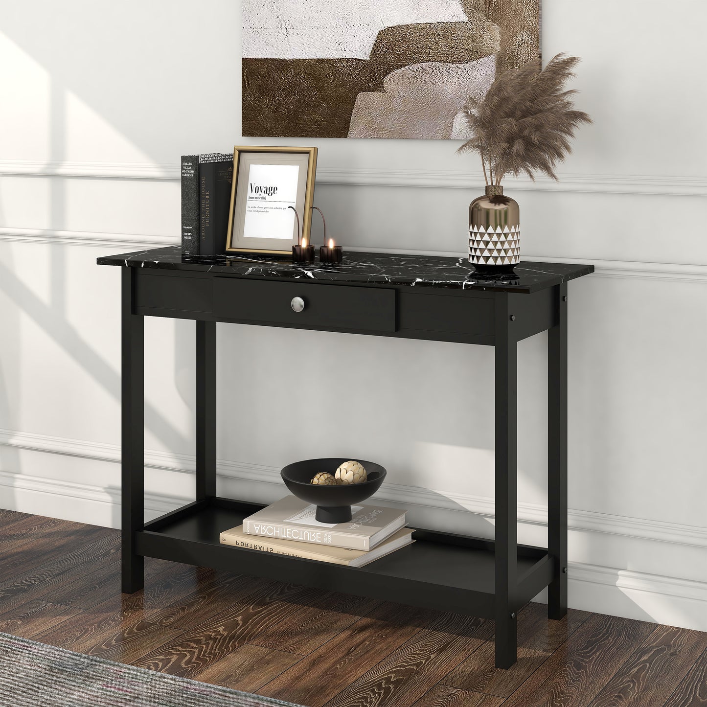 Left angled modern black and faux marble one-drawer console table with a lower shelf in a living area with accessories