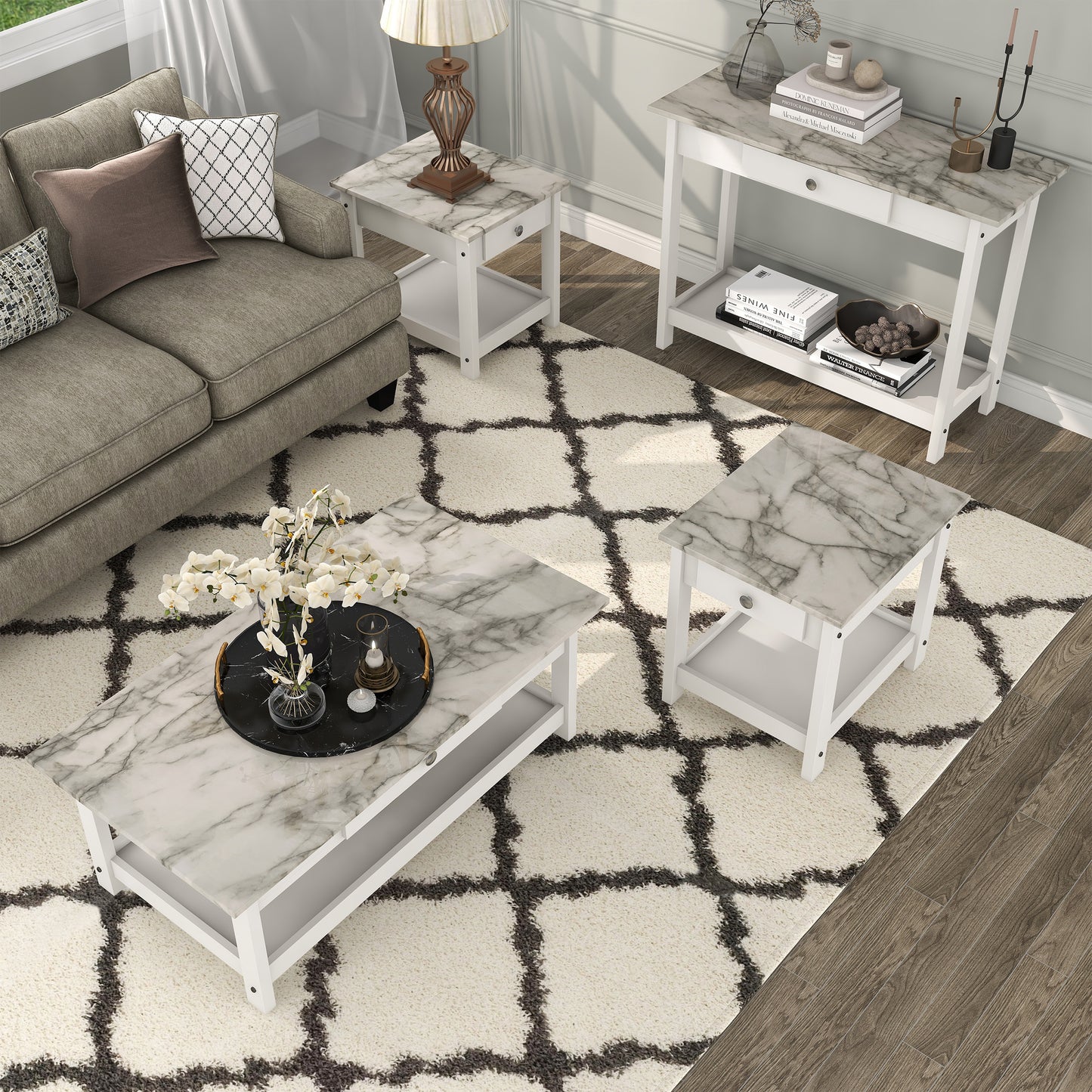 Right angled bird's eye view of a four-piece modern white and faux marble coffee table set with lower shelves in a living area with accessories