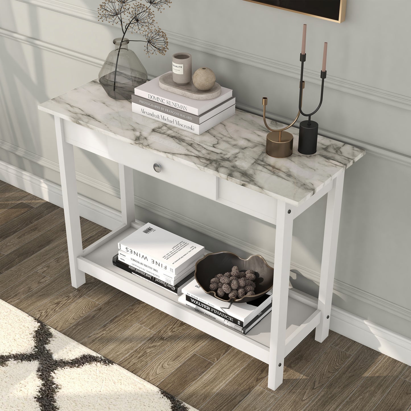 Left angled bird's eye view of a modern white and faux marble console table with a lower shelf in a living area with accessories