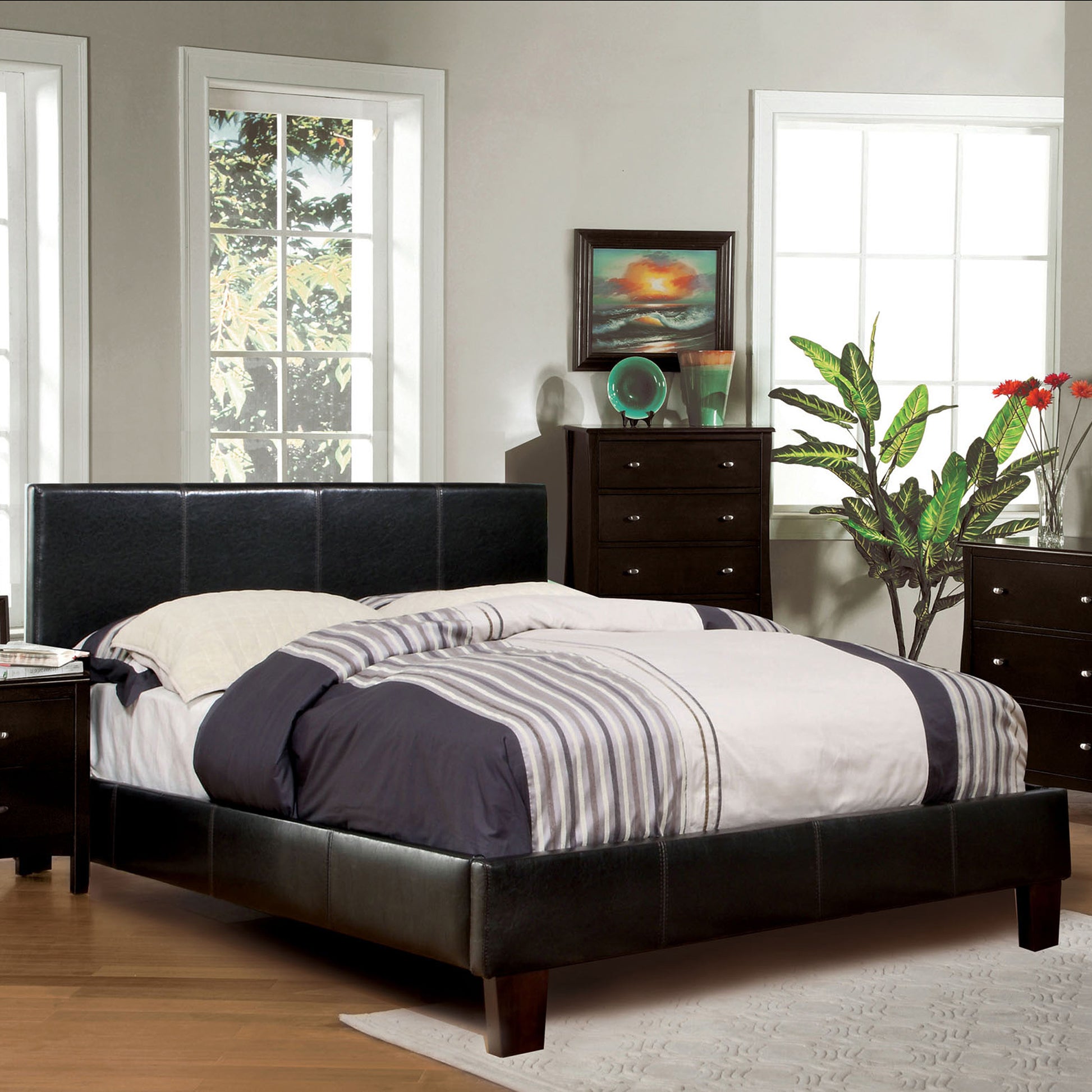 Right angled contemporary espresso faux leather platform bed in a bedroom with accessories