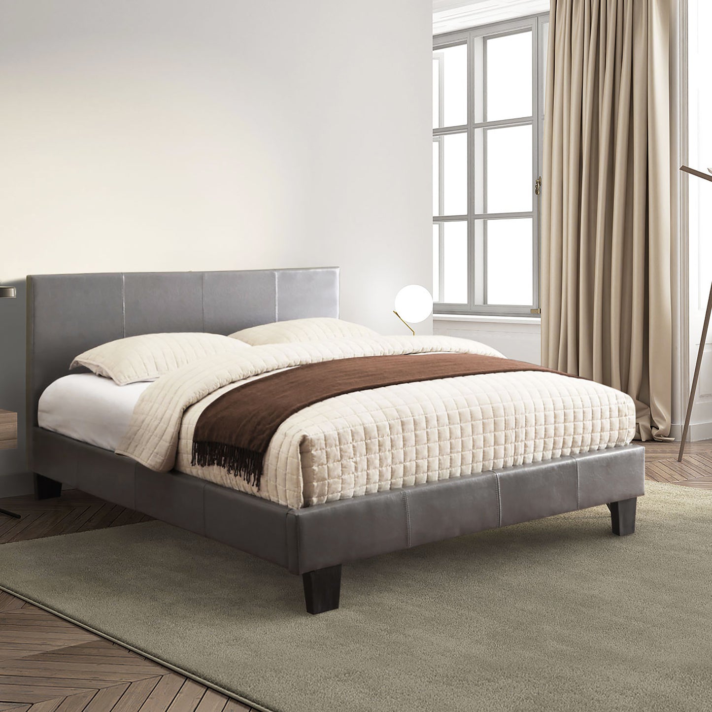 Right angled contemporary gray faux leather full platform bed in a bedroom with accessories