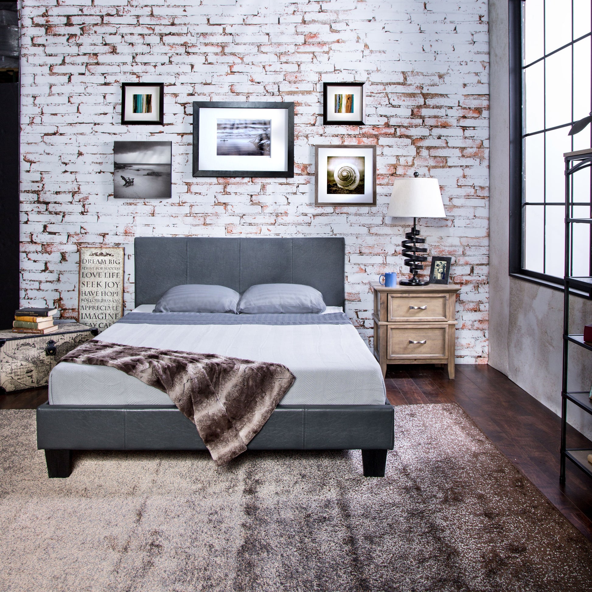 Front-facing contemporary gray faux leather full platform bed in a bedroom with accessories