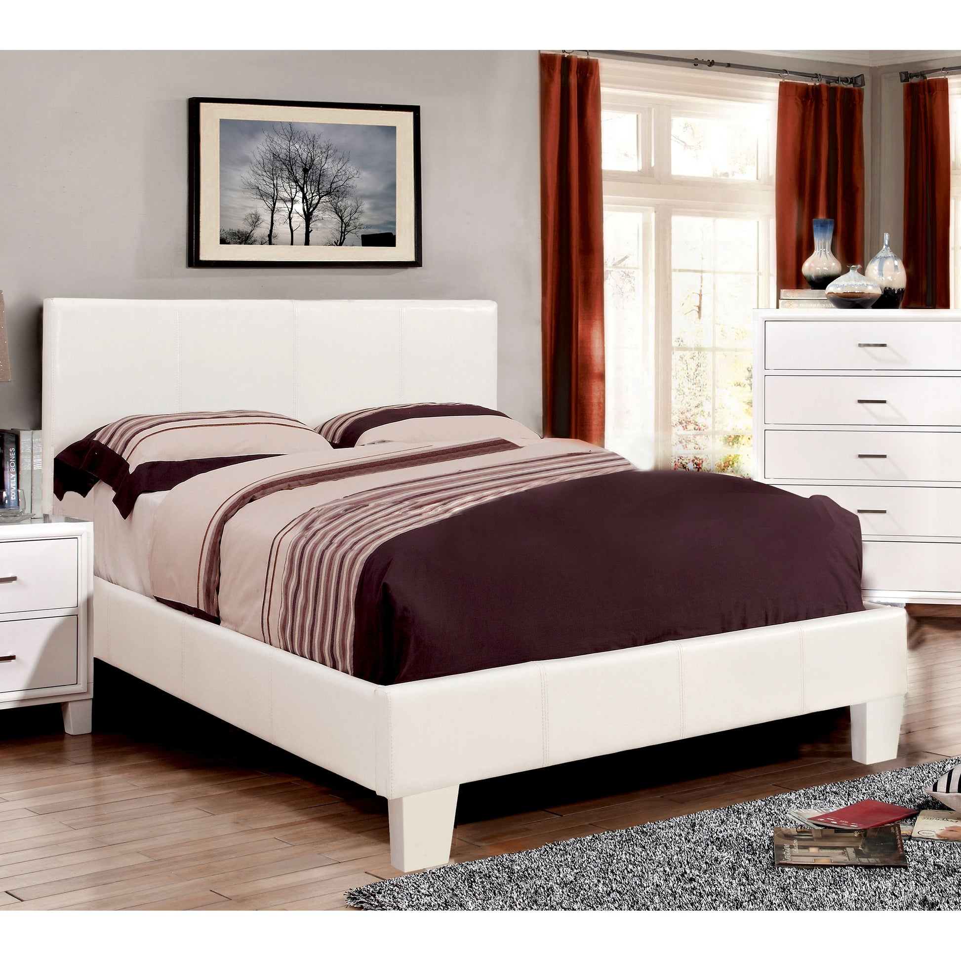 Right angled contemporary white faux leather full platform bed in a bedroom with accessories