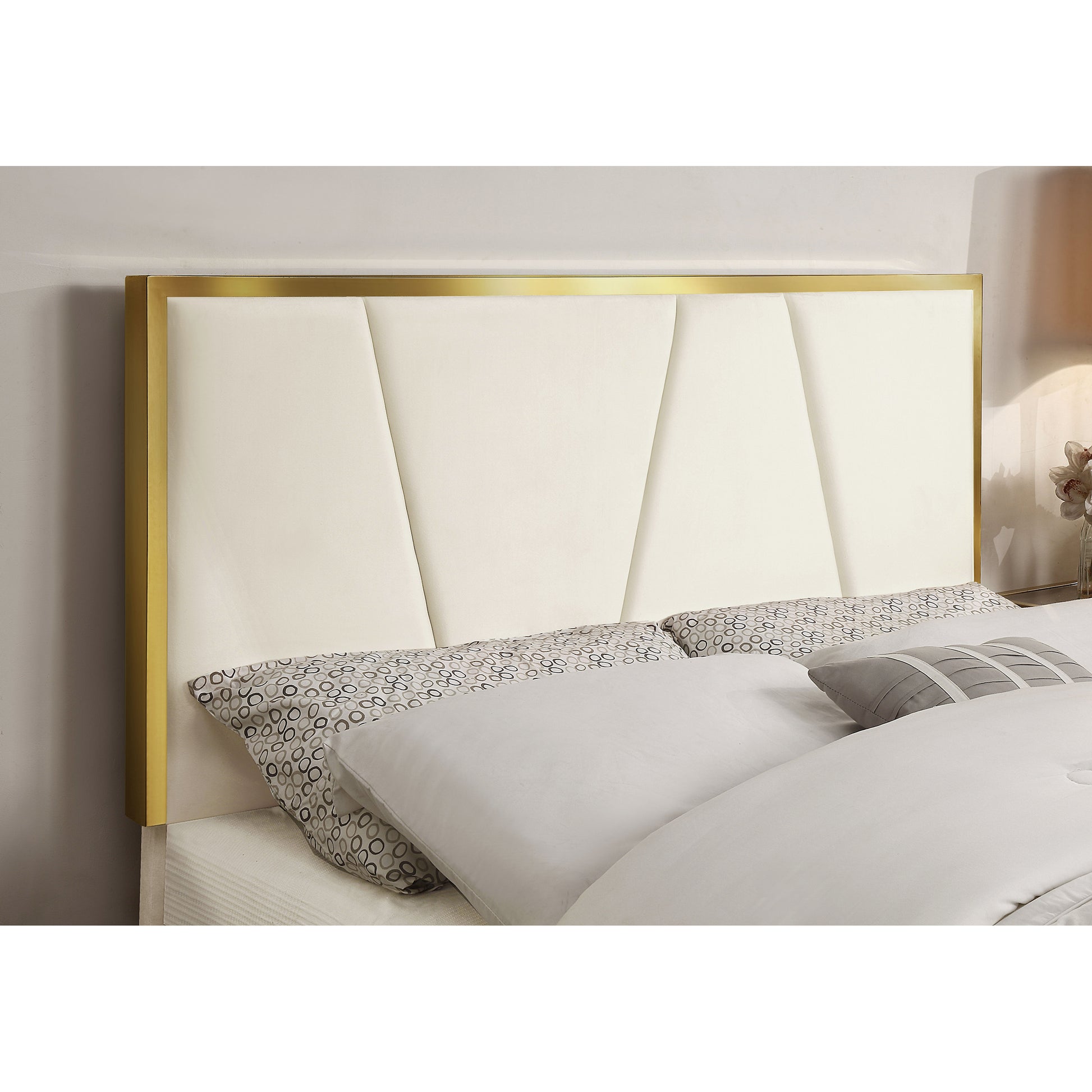 Right angled headboard close-up of a contemporary beige and gold upholstered eastern king bed in a bedroom with accessories