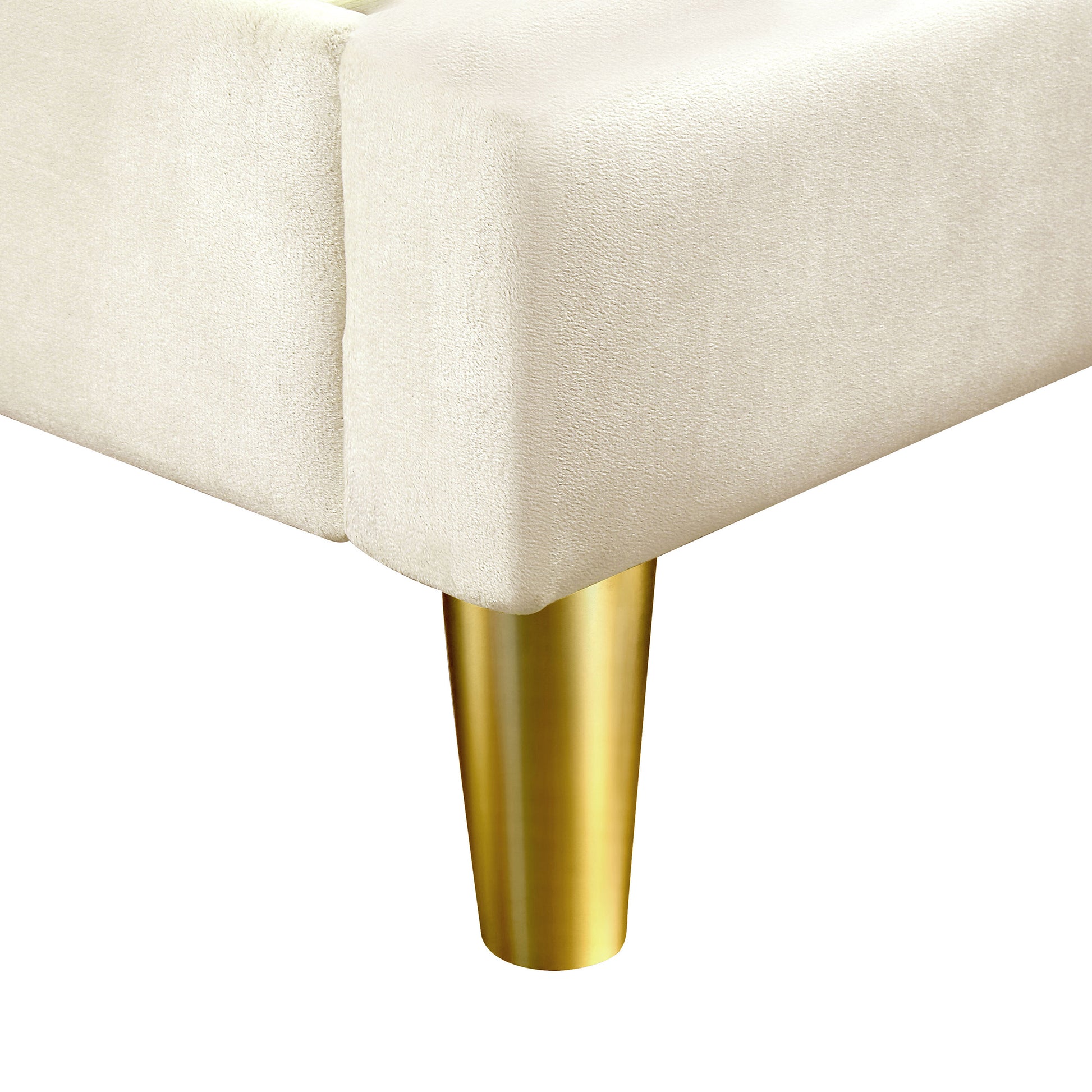 Right angled leg close-up view of a contemporary beige and gold upholstered queen bed on a white background