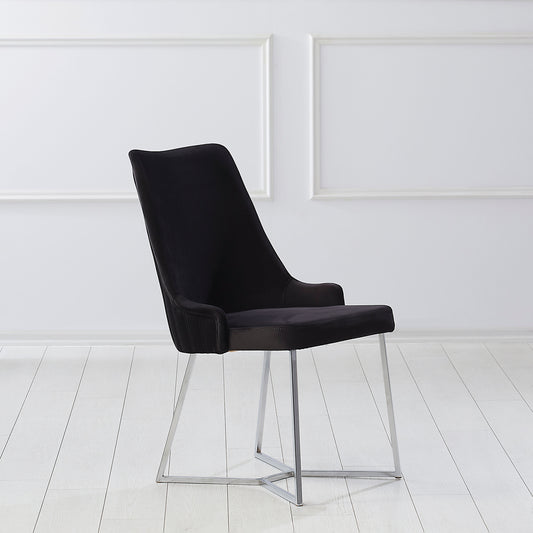 Right angled single chair only from a set of two contemporary black microfiber and silver dining chairs in an empty room with white floors