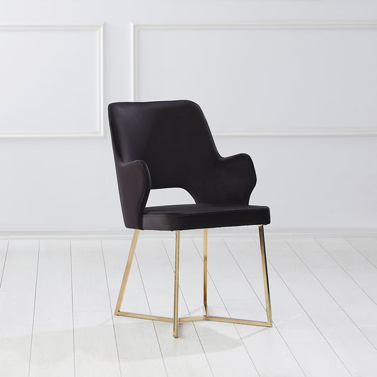 Right angled single chair only from a set of two contemporary black microfiber and gold dining chairs in an empty room with white floors