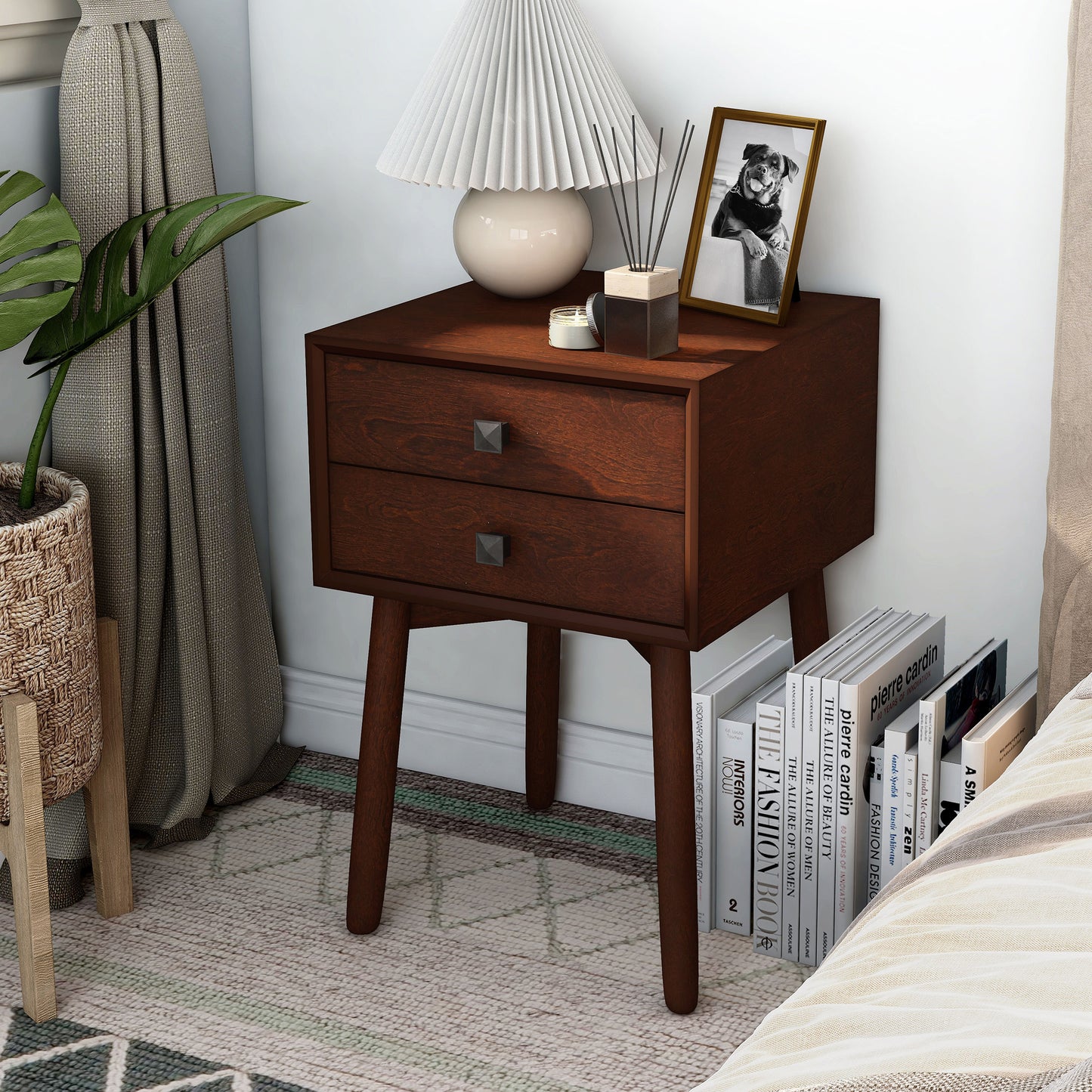 Left angled modern espresso two-drawer compact nightstand with splayed legs in a bedroom with accessories