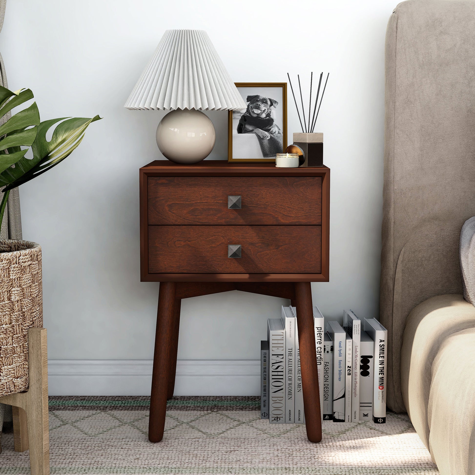 Front-facing modern espresso two-drawer compact nightstand with splayed legs in a bedroom with accessories