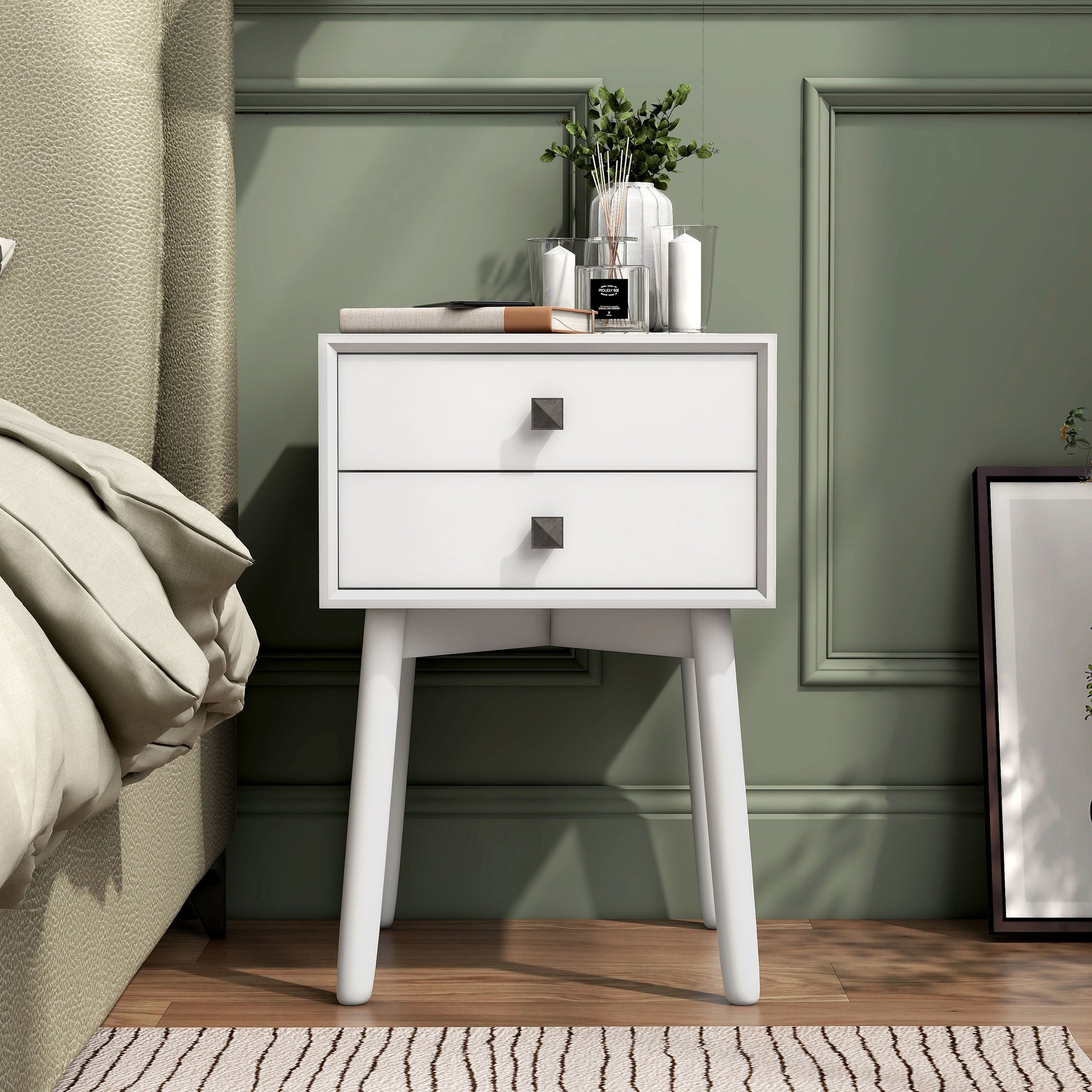 Front-facing modern white two-drawer compact nightstand with splayed legs in a bedroom with accessories