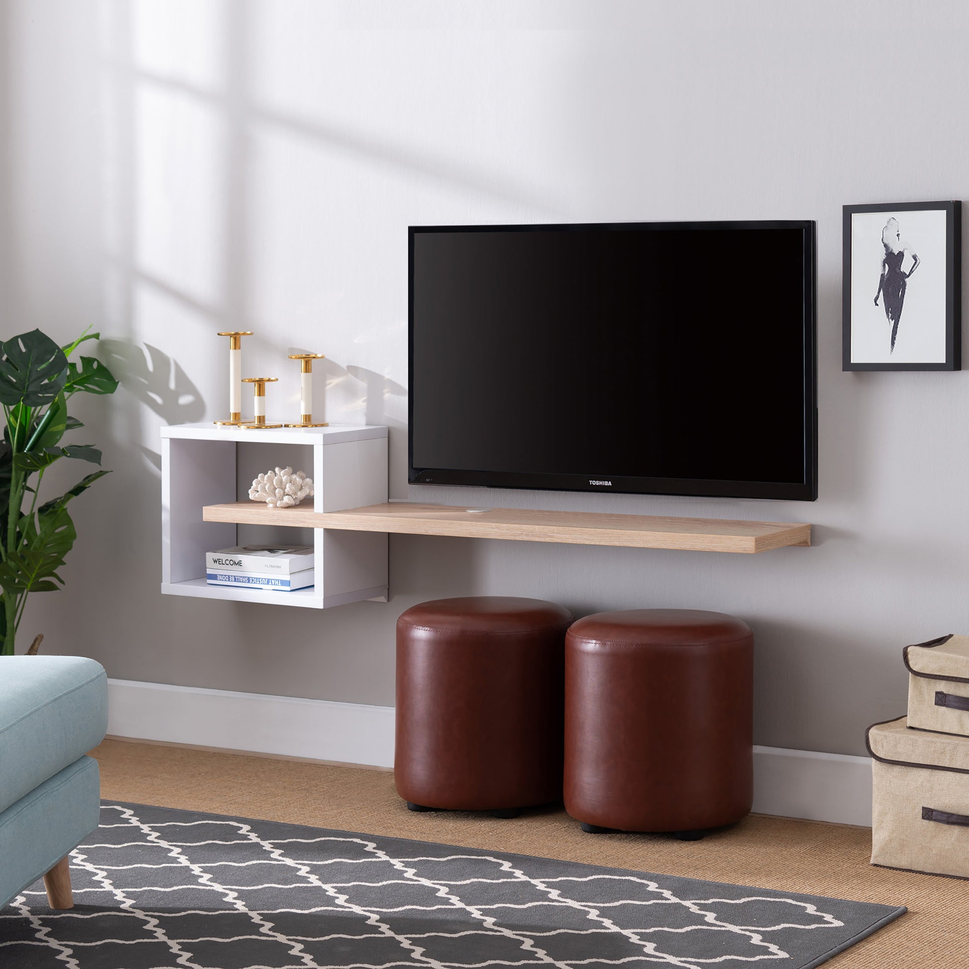 Left angled modern white and light oak cube and open shelf floating TV stand in a living room with accessories